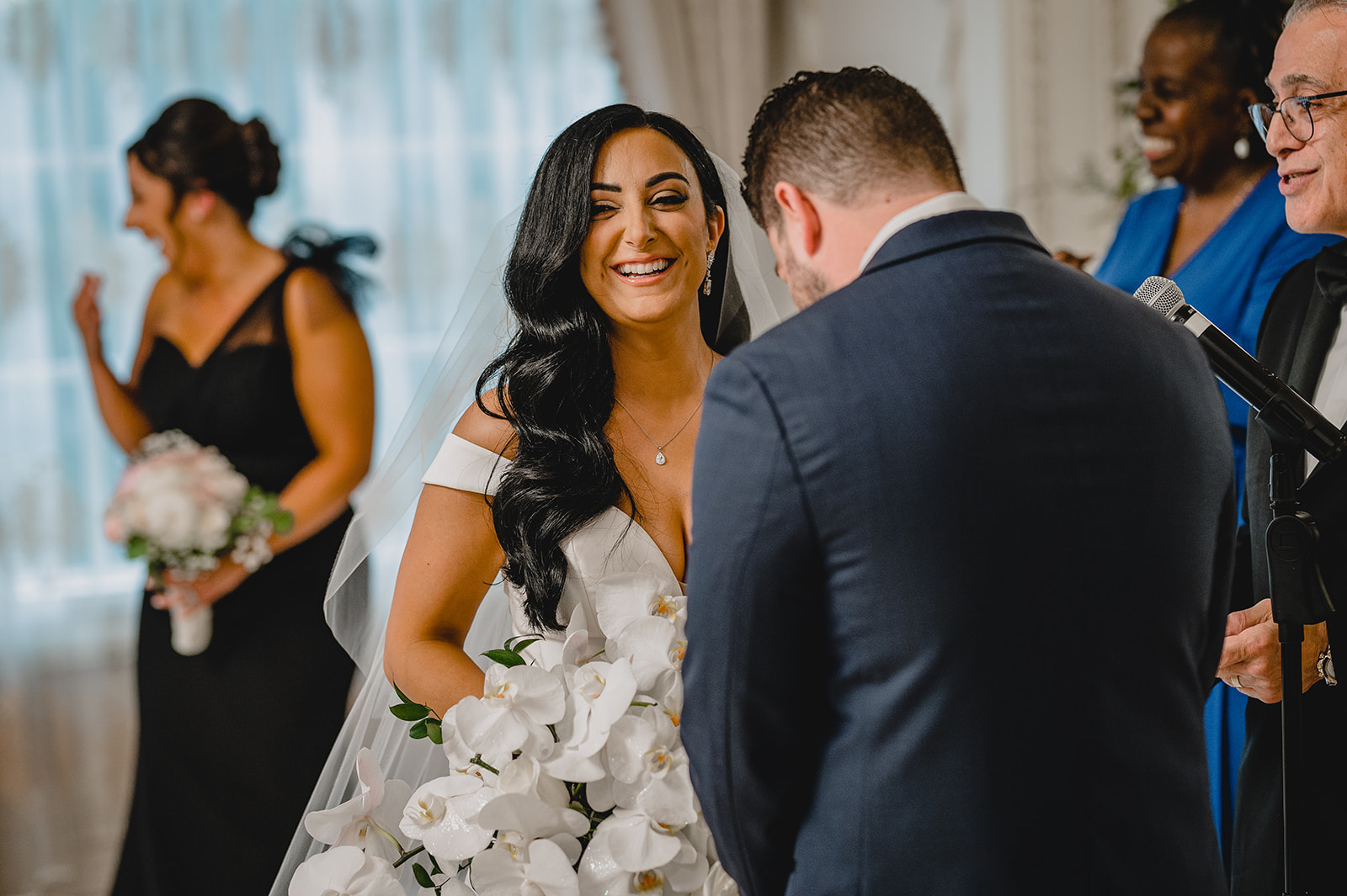 bride and groom laugh during their wedding ceremony