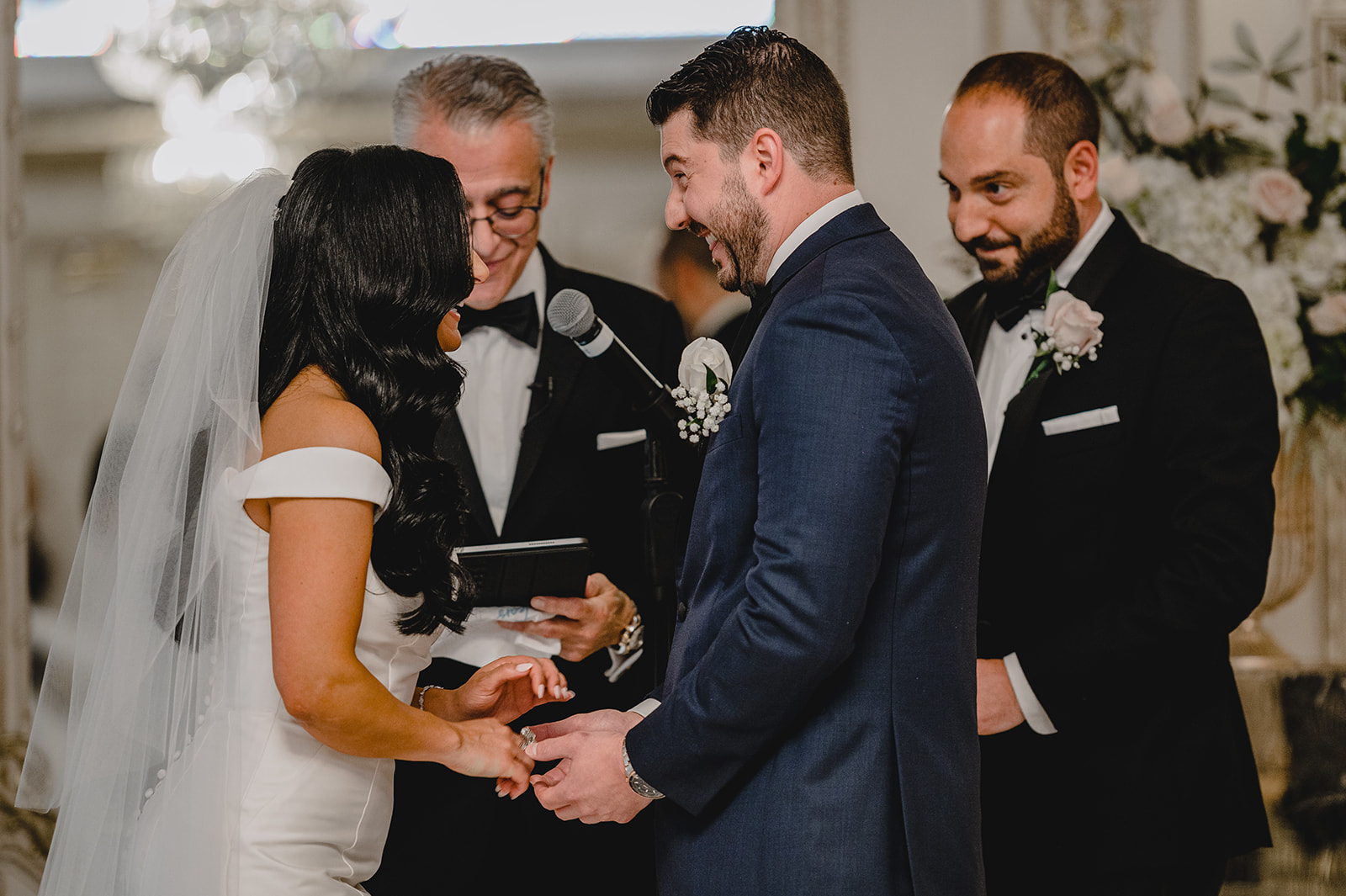 newlyweds hold hands during wedding ceremony inside the Venetian