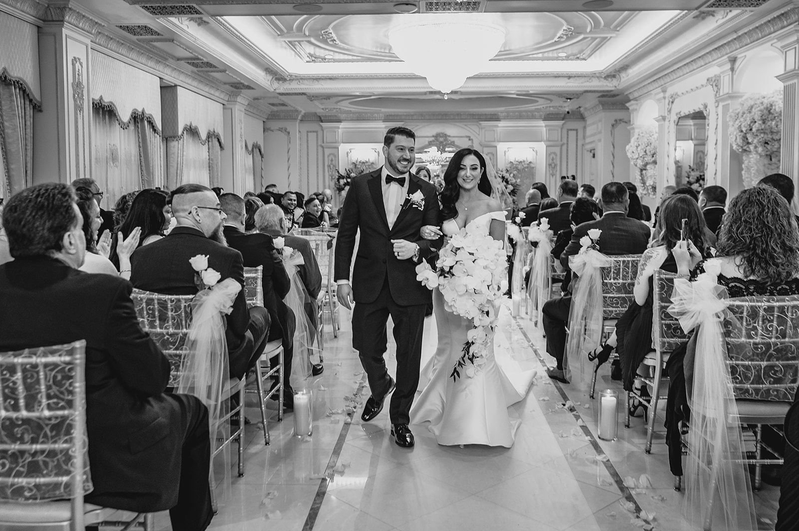 groom and bride walk up aisle after ceremony inside the Venetian