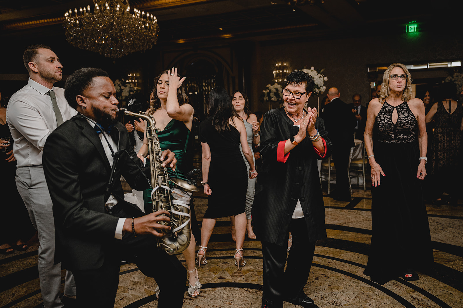 live band performs while guests clap on the dance floor