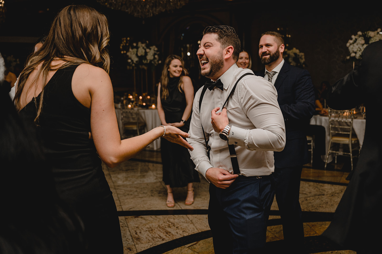 groom dances with guests during NJ wedding reception