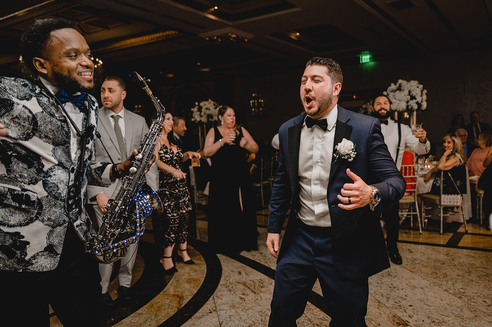 groom sings on dance floor during NJ wedding reception