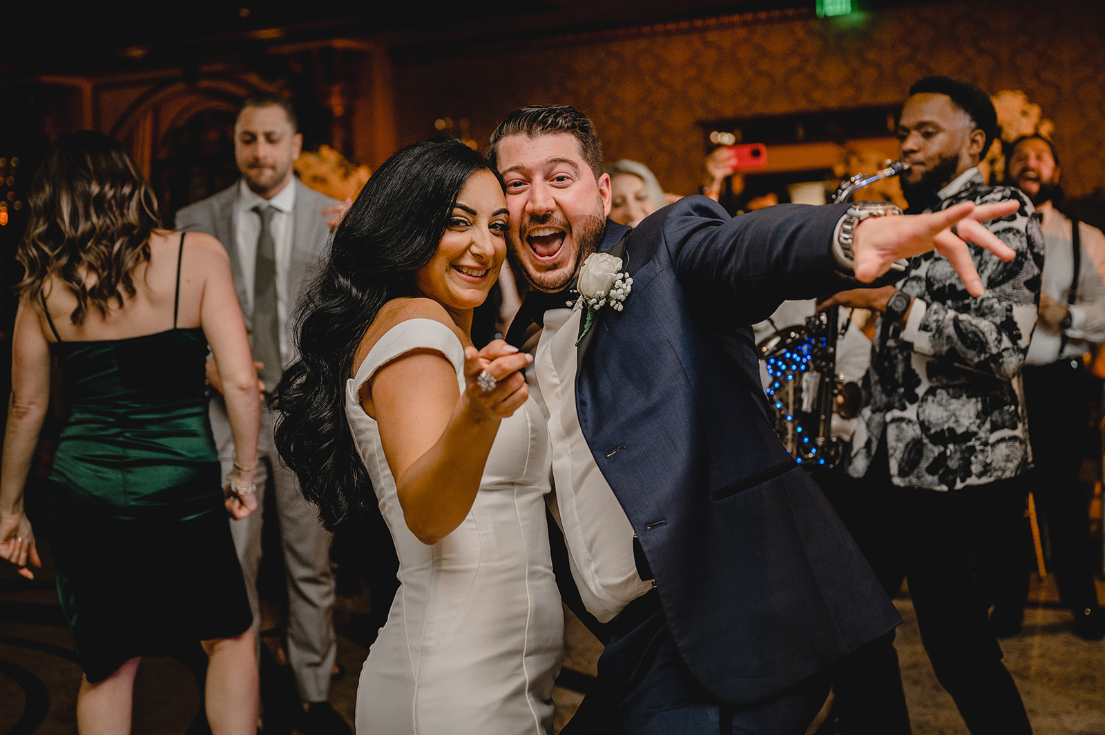 bride and groom smile together on dance floor