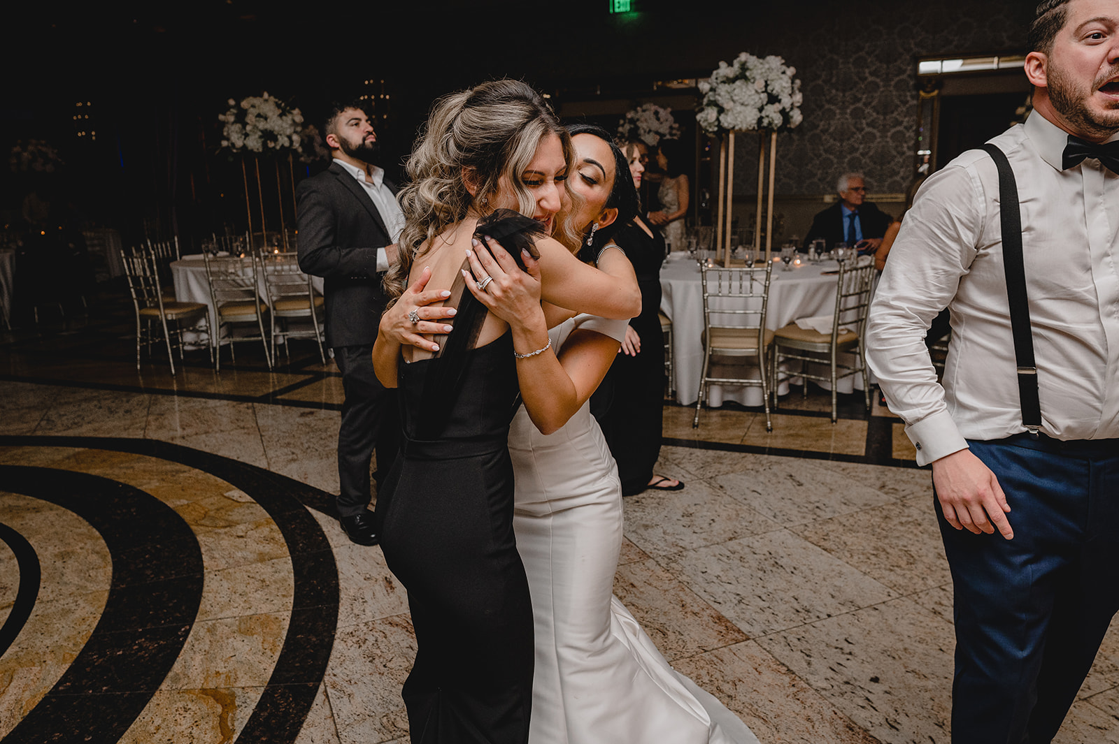 bride hugs guest during NJ wedding reception