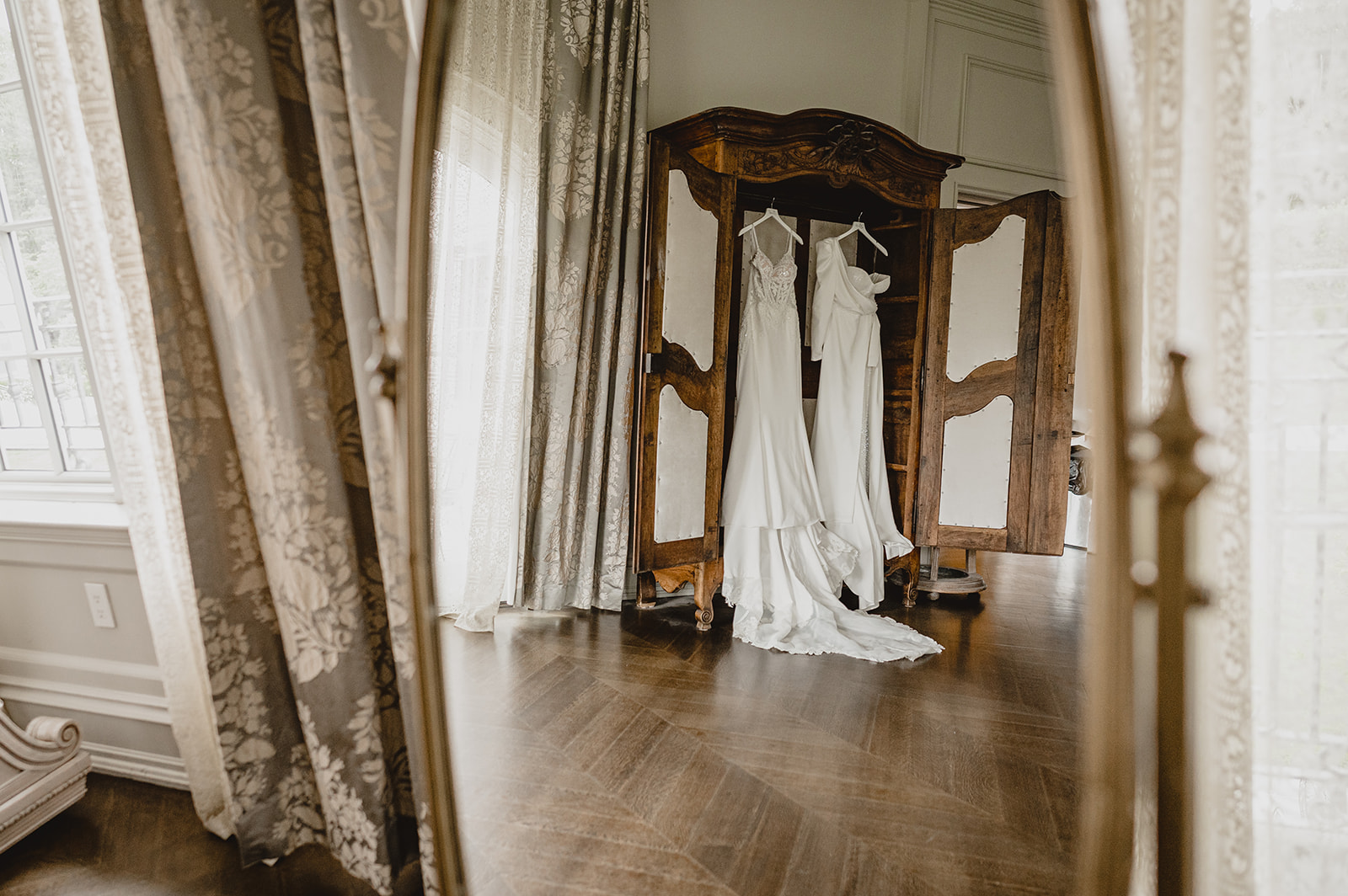 two wedding gowns hanging in bridal suite at Park Chateau Estate