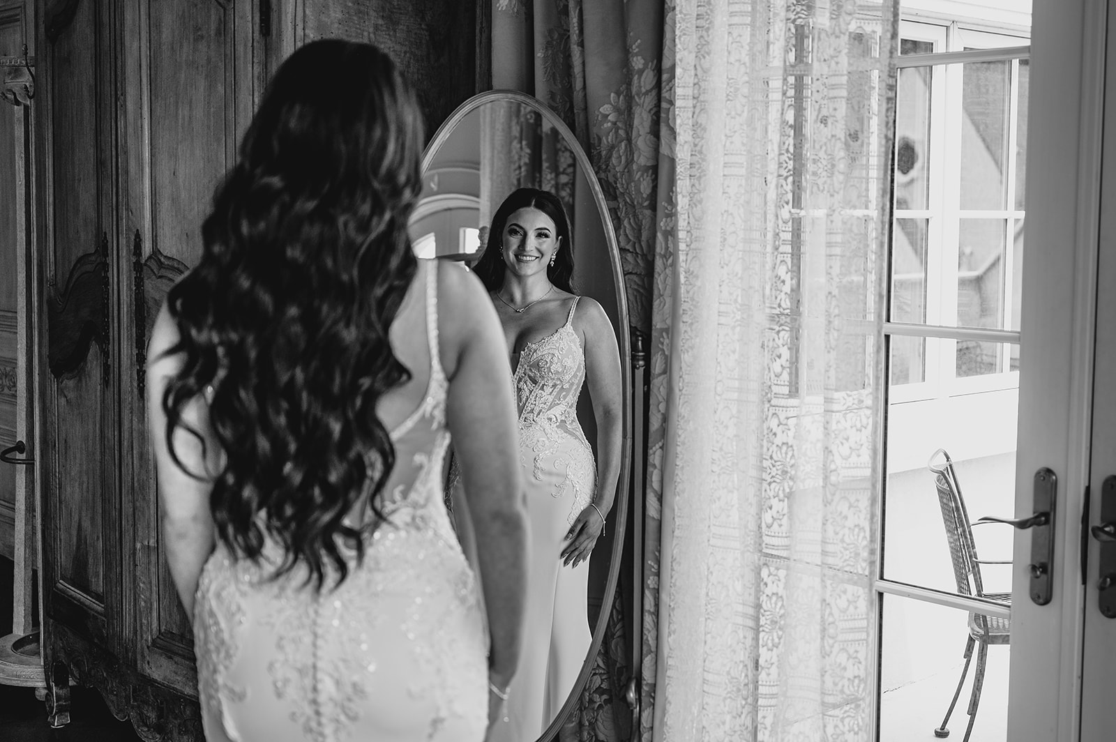 bride looks in mirror in the bridal suite at Park Chateau Estate