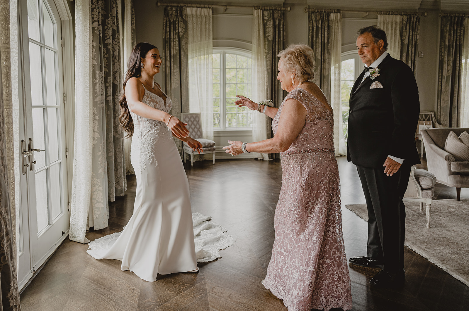 mother walks towards bride during prep in suite at Park Chateau Estate