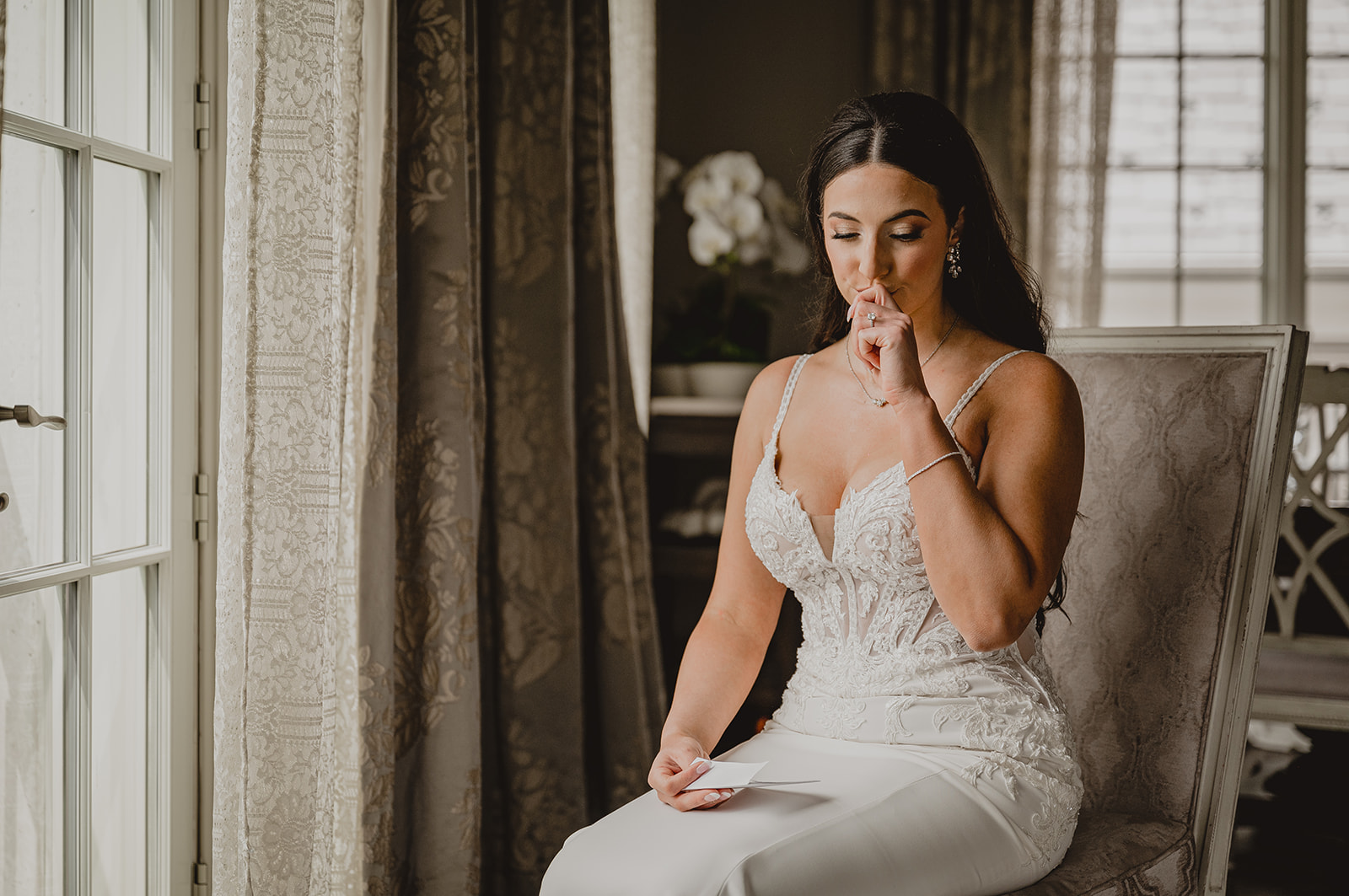 bride holds back tears during prep for wedding day