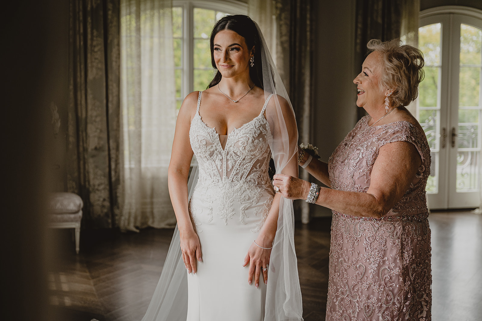 mother helps bride with veil in suite at Park Chateau Estate