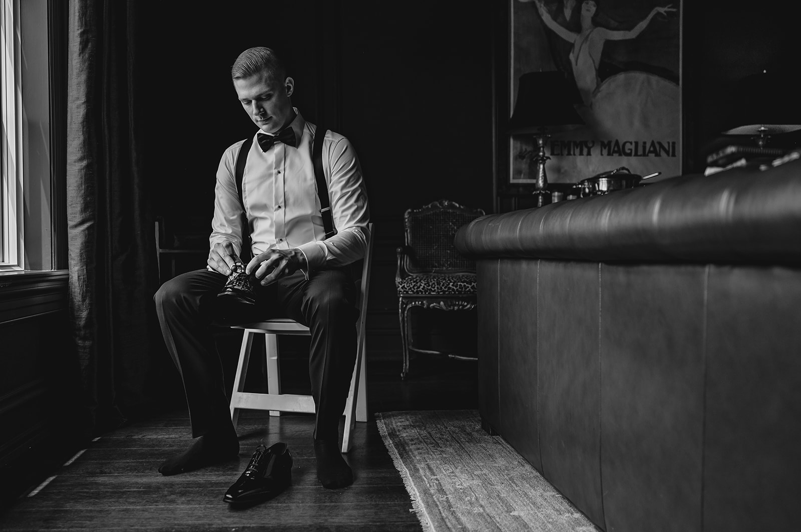 groom sits in folding chair adjusting cufflinks