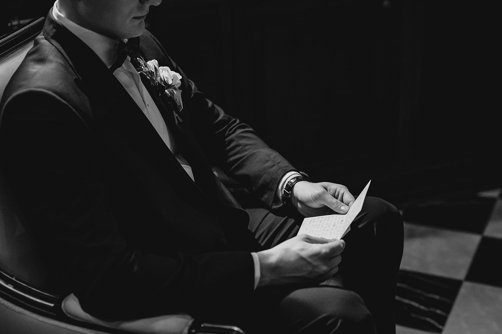 groom reads letter inside the library at Park Chateau Estate