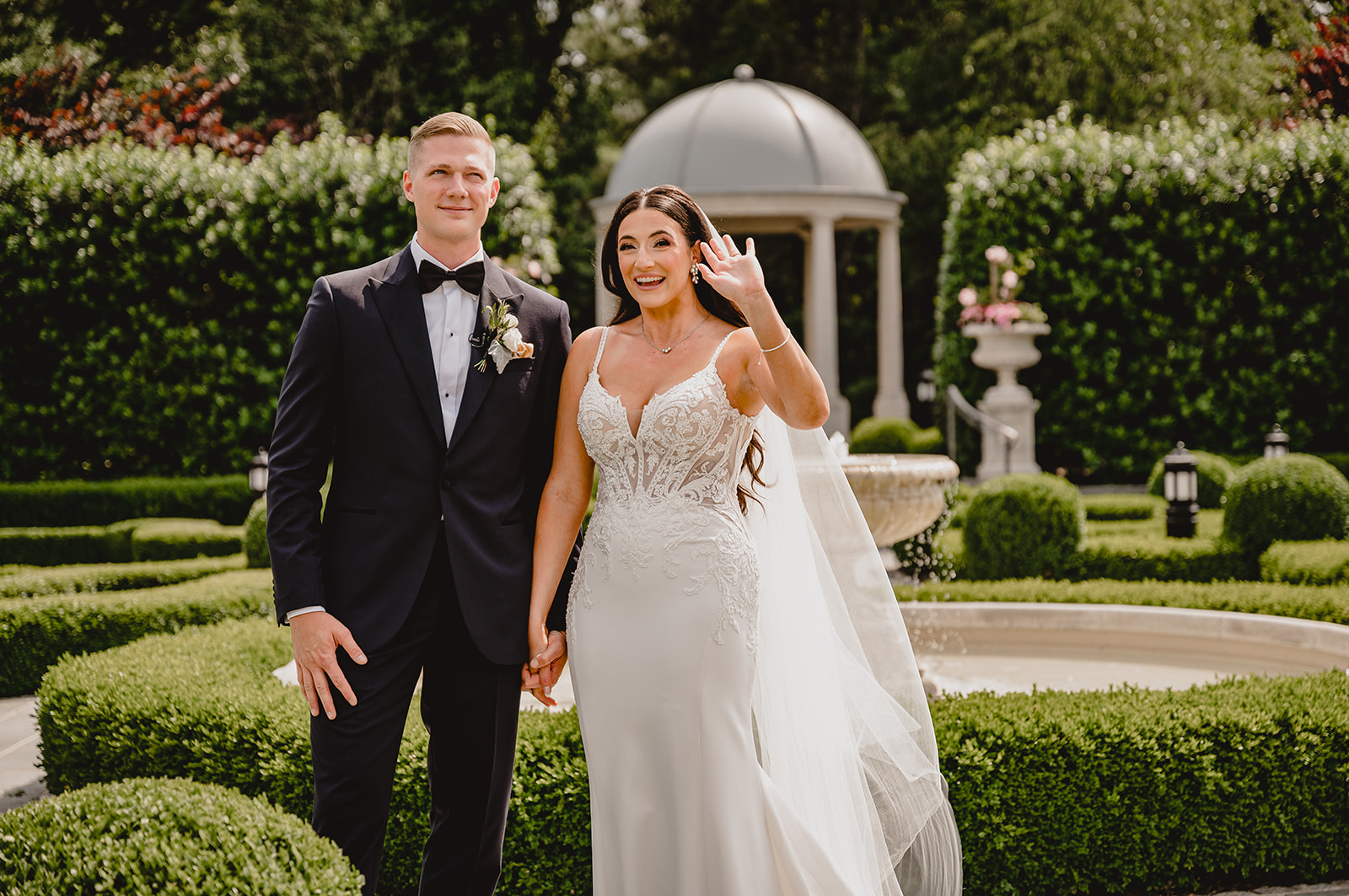 bride and groom cheer in gardens of Park Chateau Estate