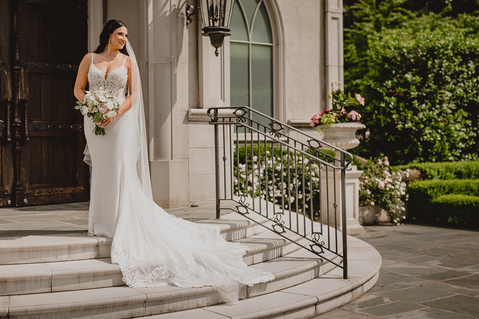 bride stands on top of stairs at Park Chateau chapel