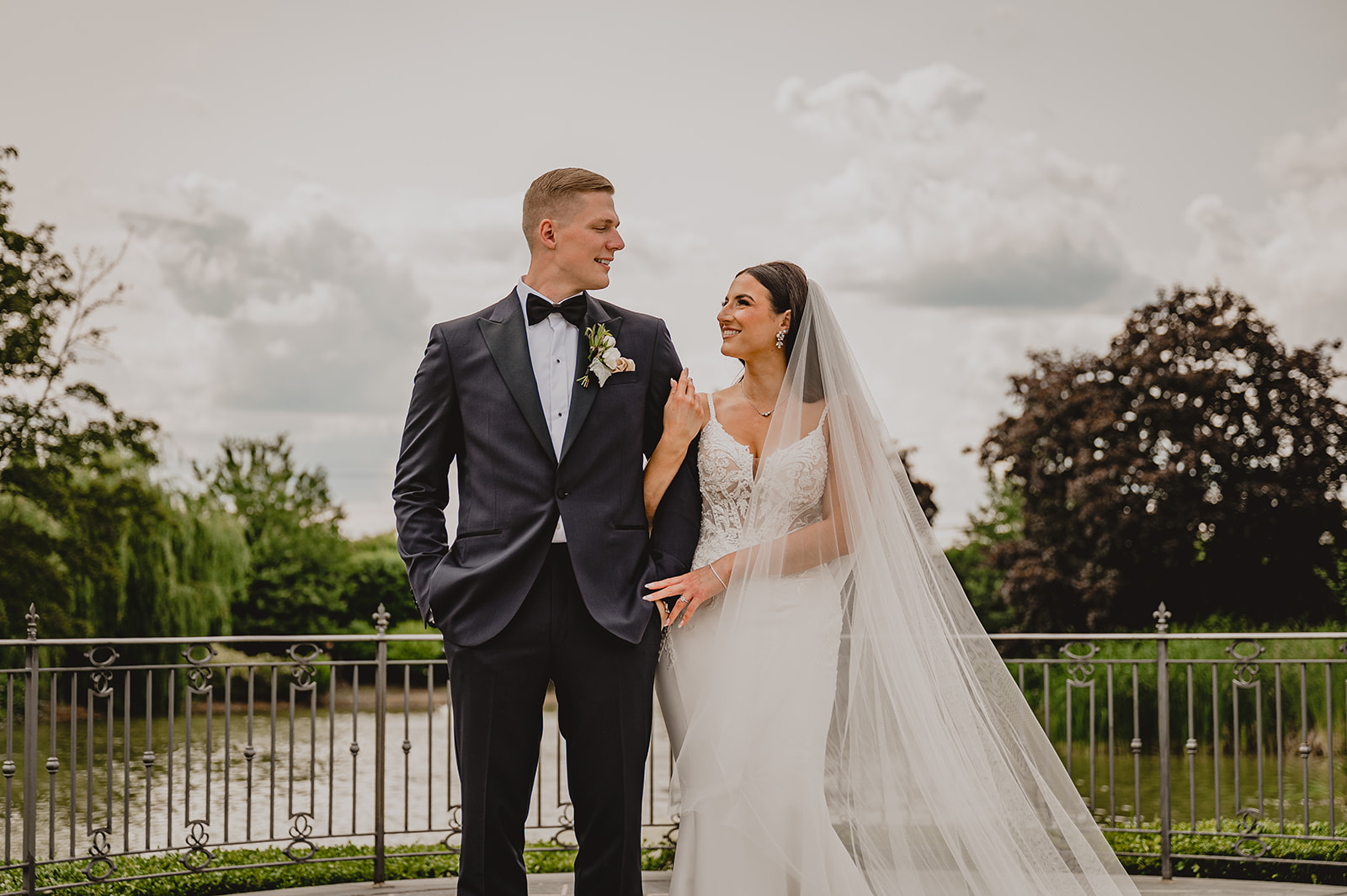 bride holds groom's arm on patio at Park Chateau Estate