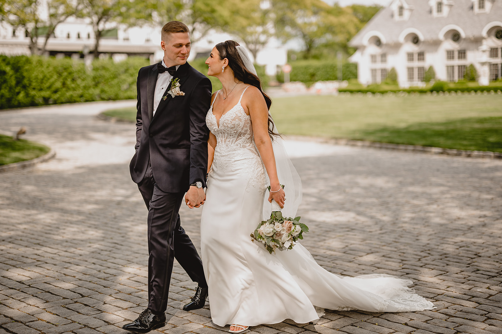 bride and groom hold hands walking outside Park Chateau Estate