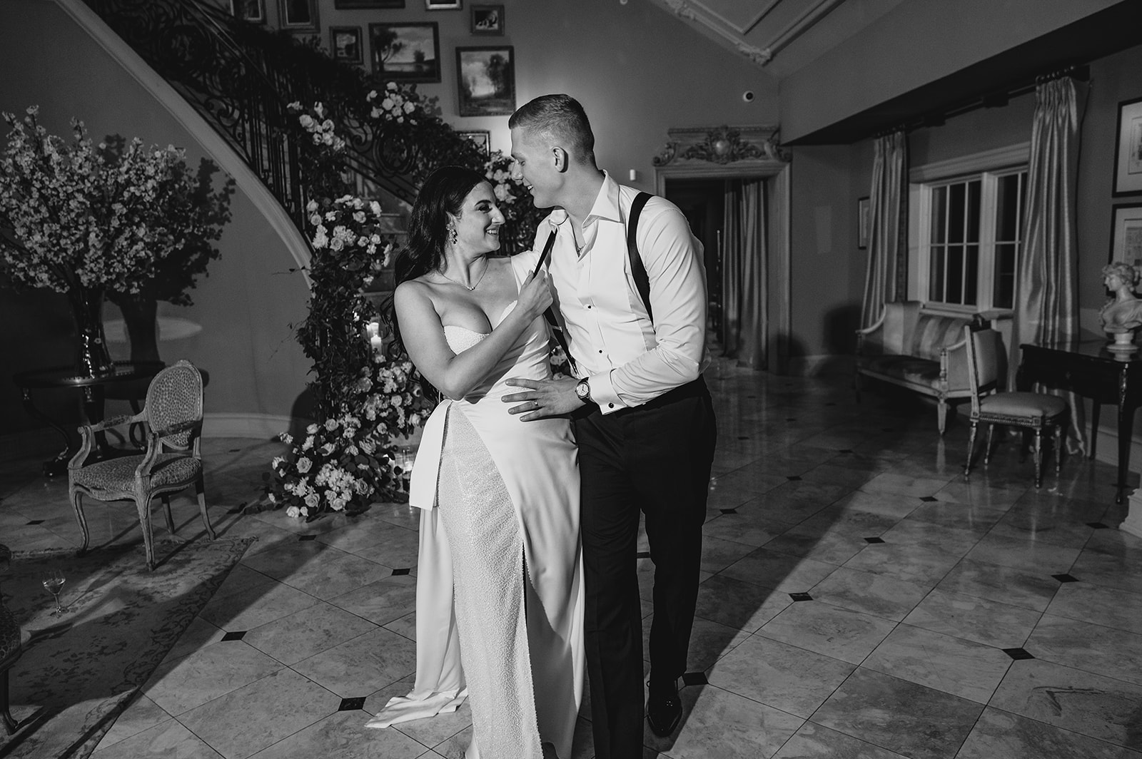 bride and groom walk away from staircase inside Park Chateau Estate