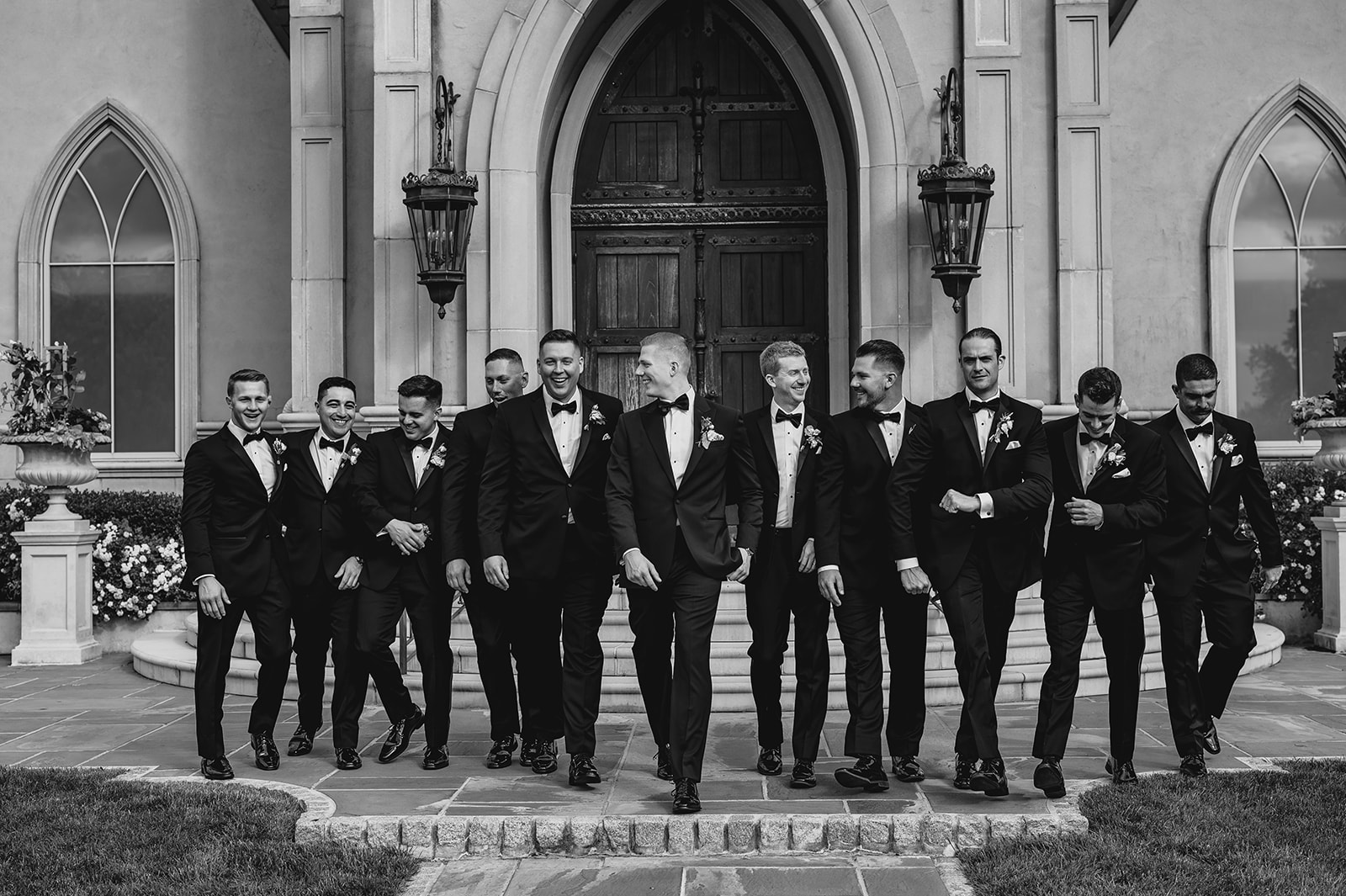 groom walks with groomsmen outside leaving the Park Chateau Estate chapel