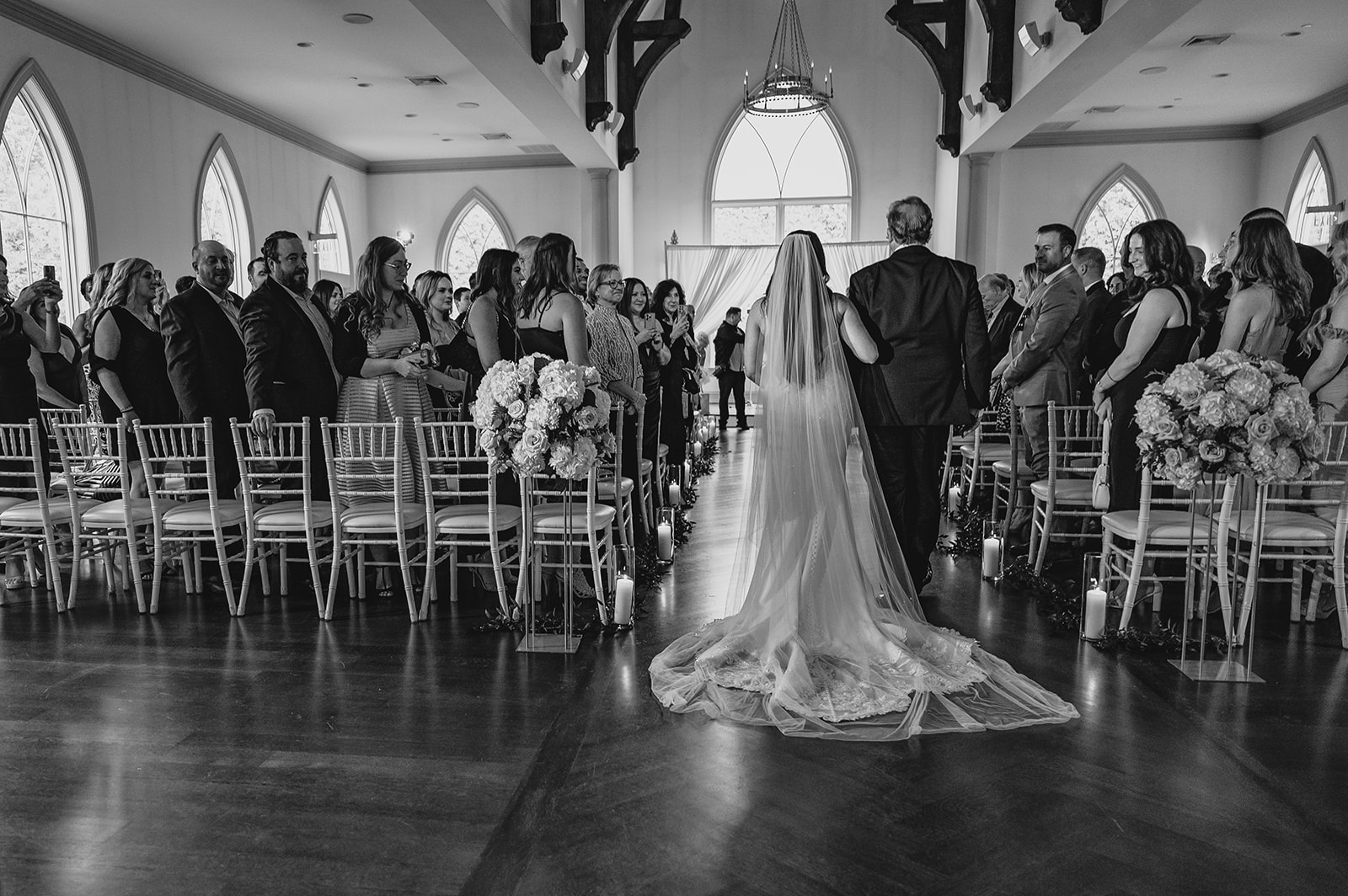 father escorts bride into ceremony inside the chapel at Park Chateau Estate