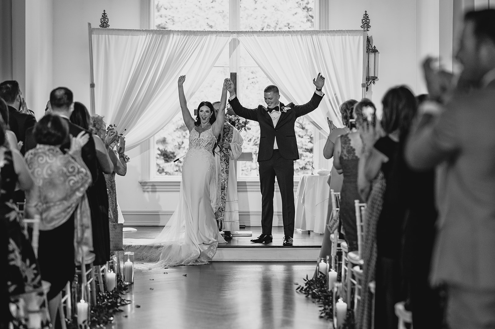 newlyweds cheer leaving ceremony inside the chapel at Park Chateau Estate