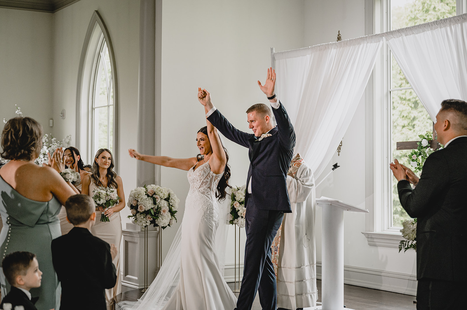 bride and groom cheer leaving ceremony inside the chapel at Park Chateau Estate