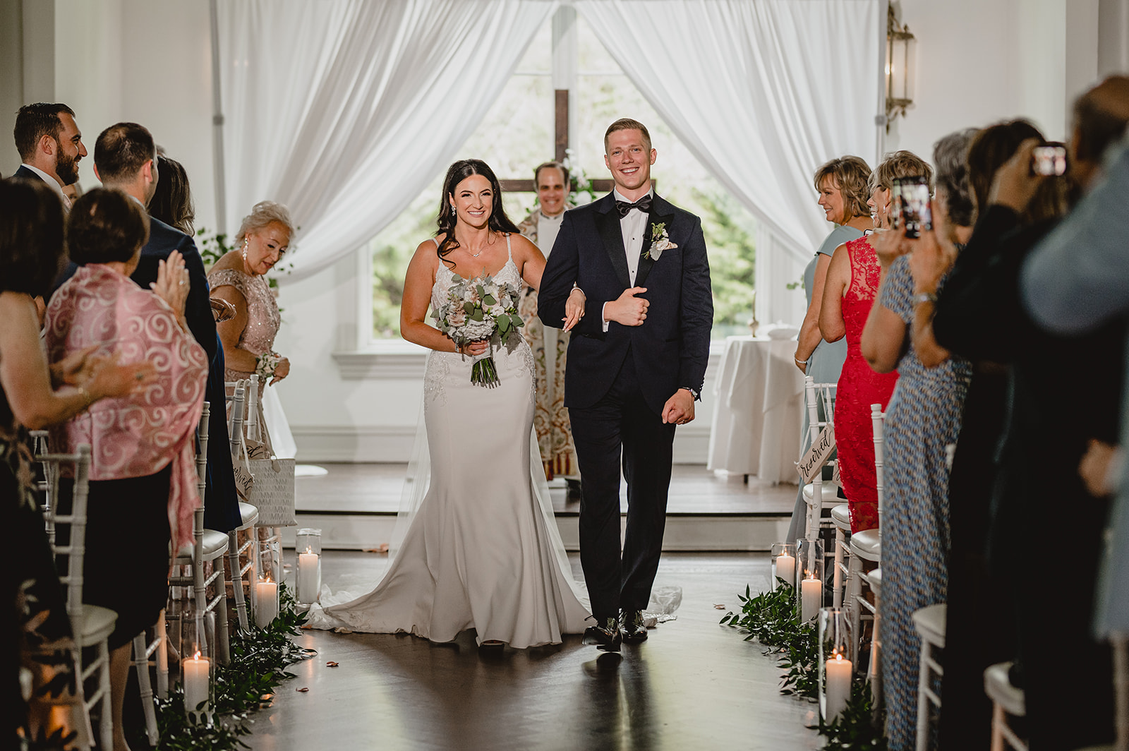 bride and groom walk up aisle after ceremony inside the chapel at Park Chateau Estate