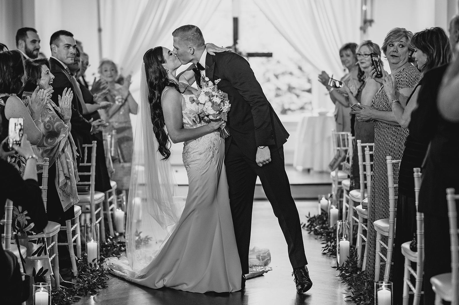 bride and groom kiss during ceremony inside the chapel at Park Chateau Estate