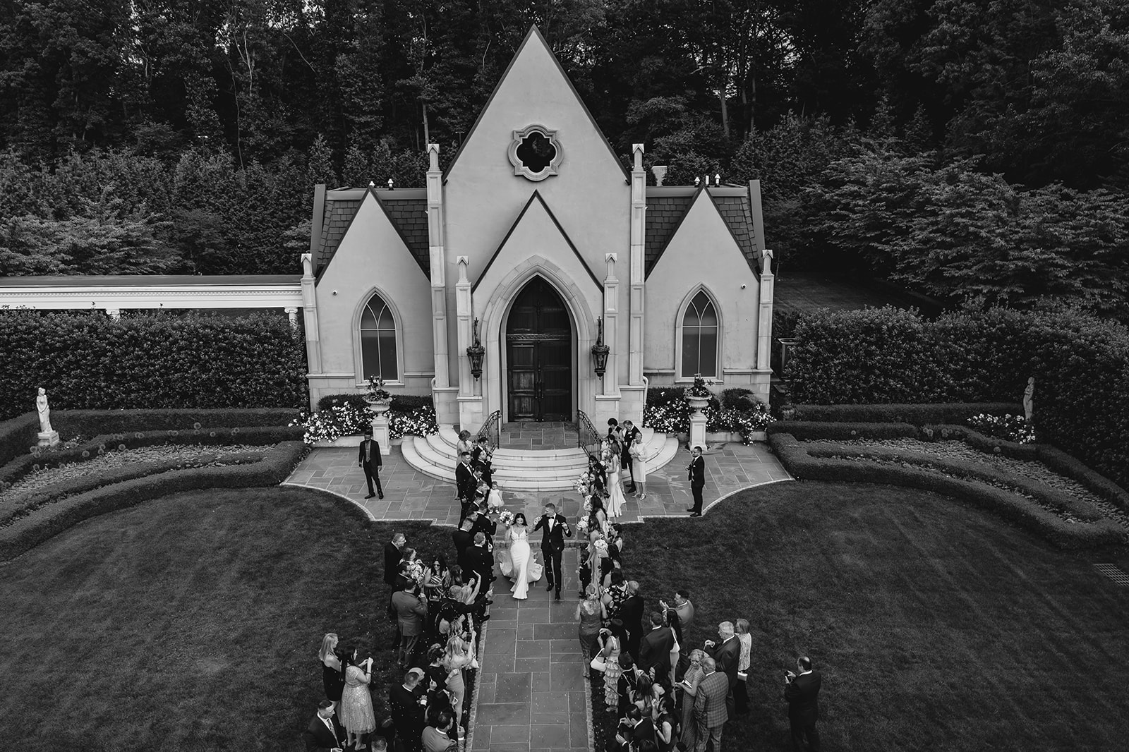 drone photo of couple leaving leaving the Park Chateau Estate chapel