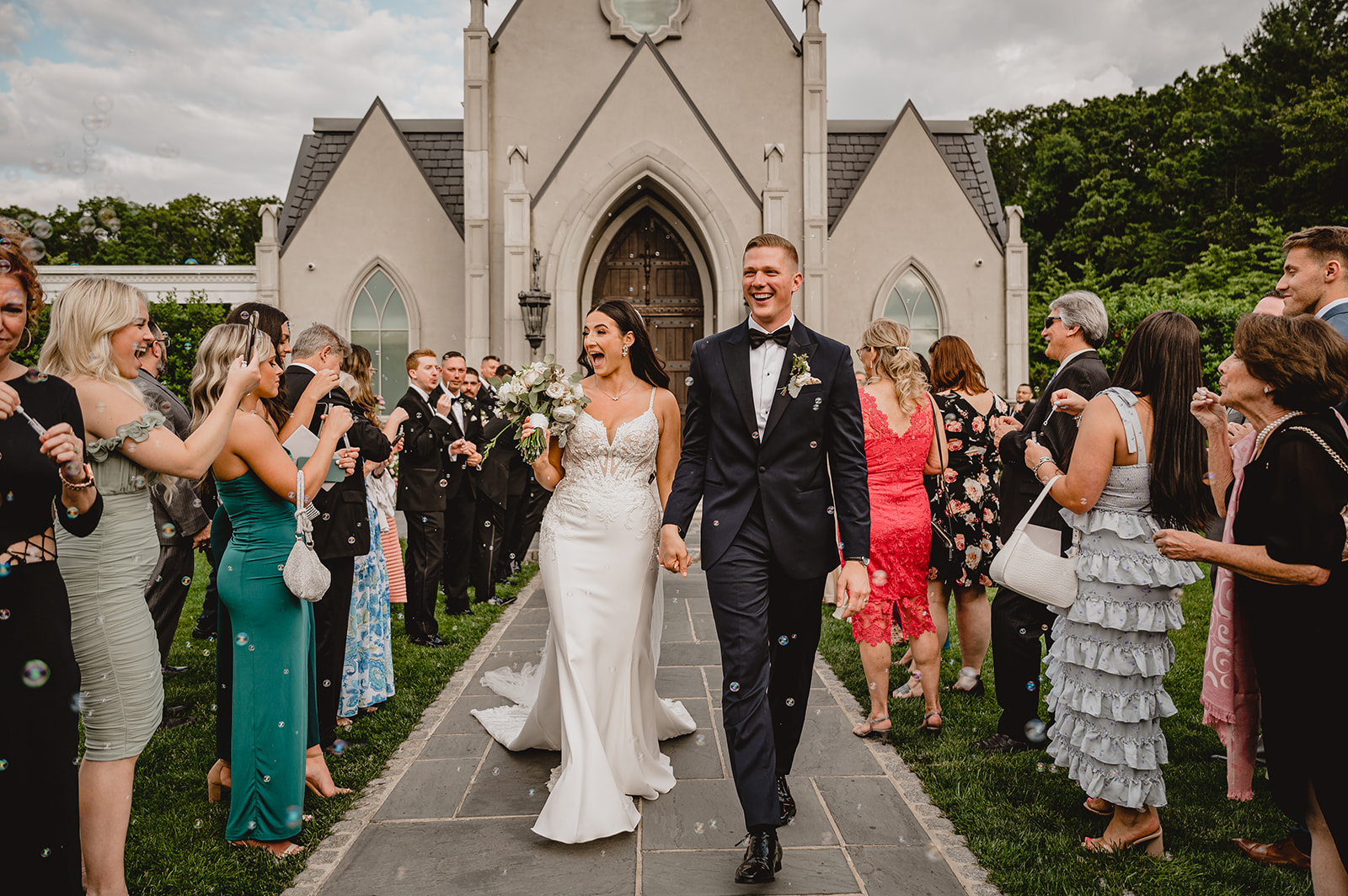 bride and groom hold hands leaving leaving the Park Chateau Estate chapel