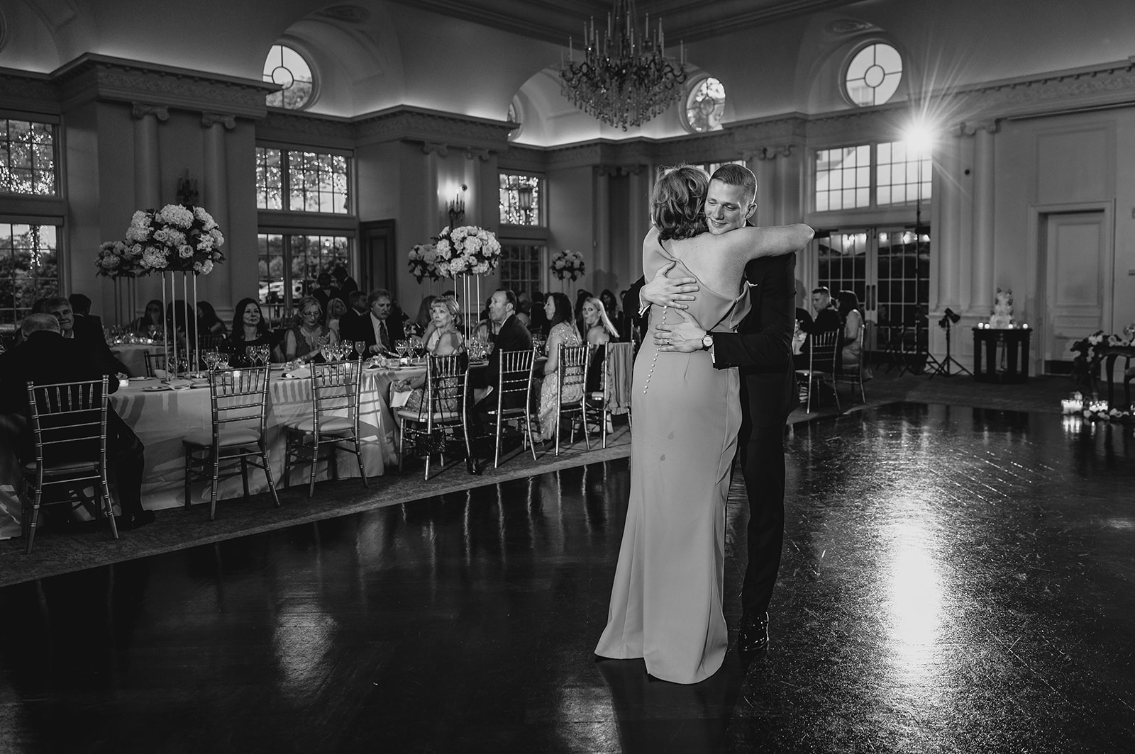 groom hugs mother on dance floor of NJ wedding reception