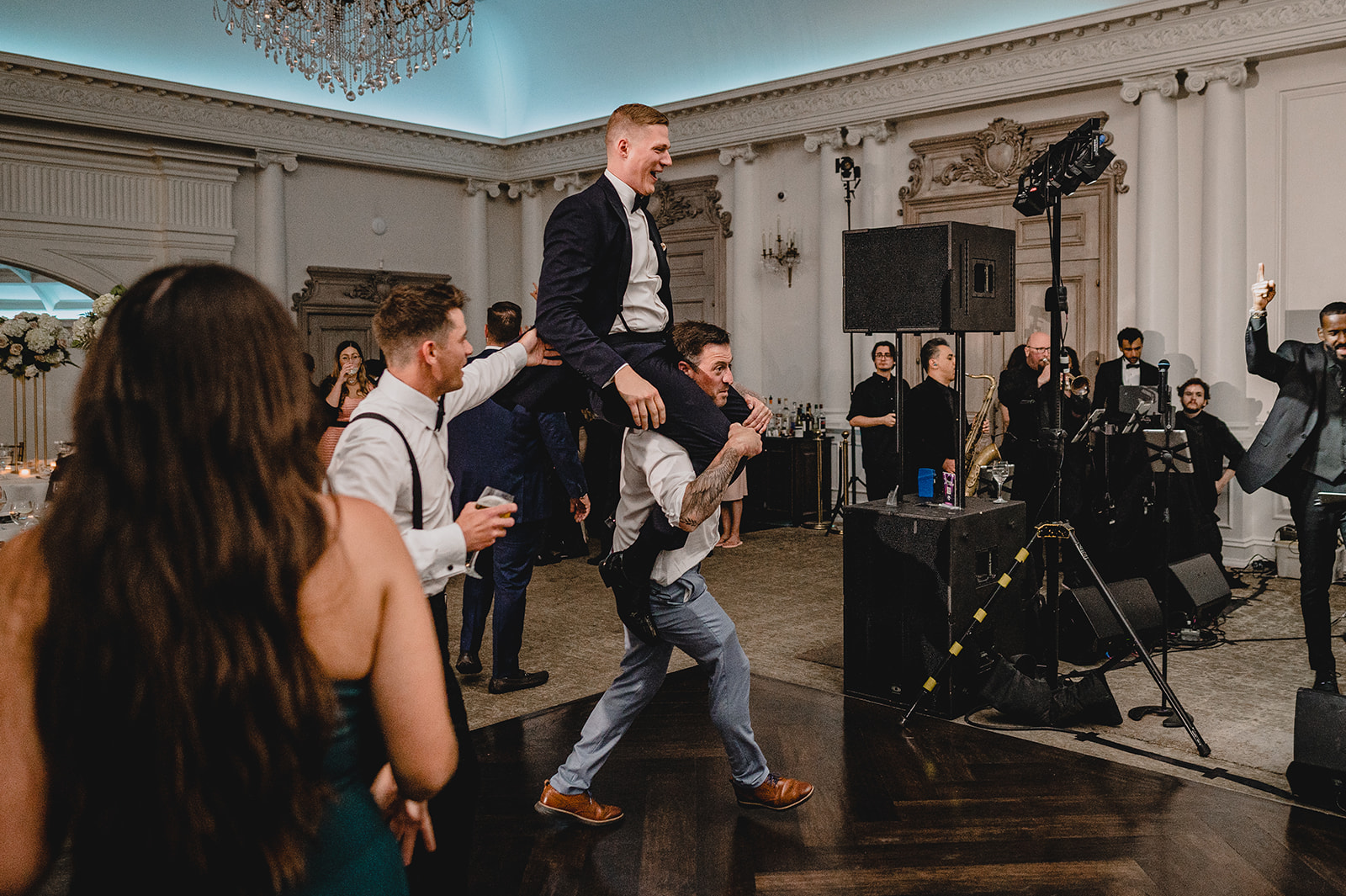 guest lift up groom to stage during NJ wedding reception