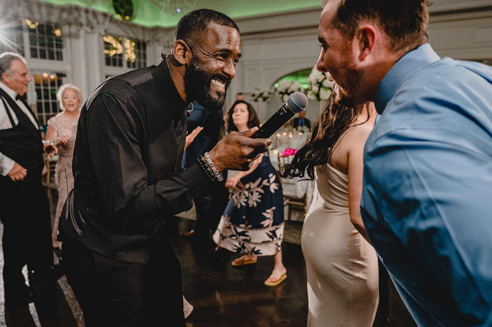 singer holds mic out to guest during NJ wedding reception