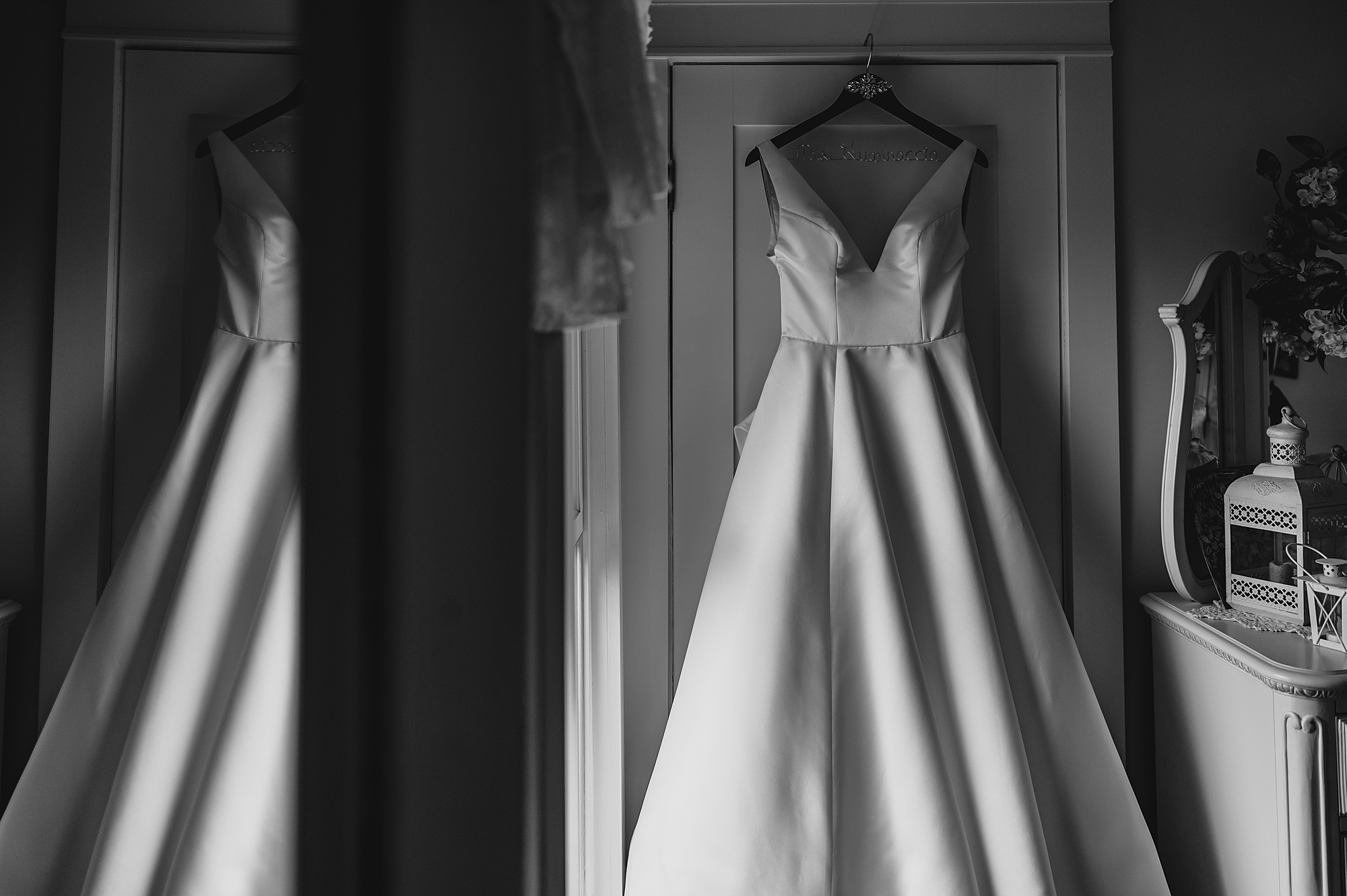 wedding dress hangs on closet door