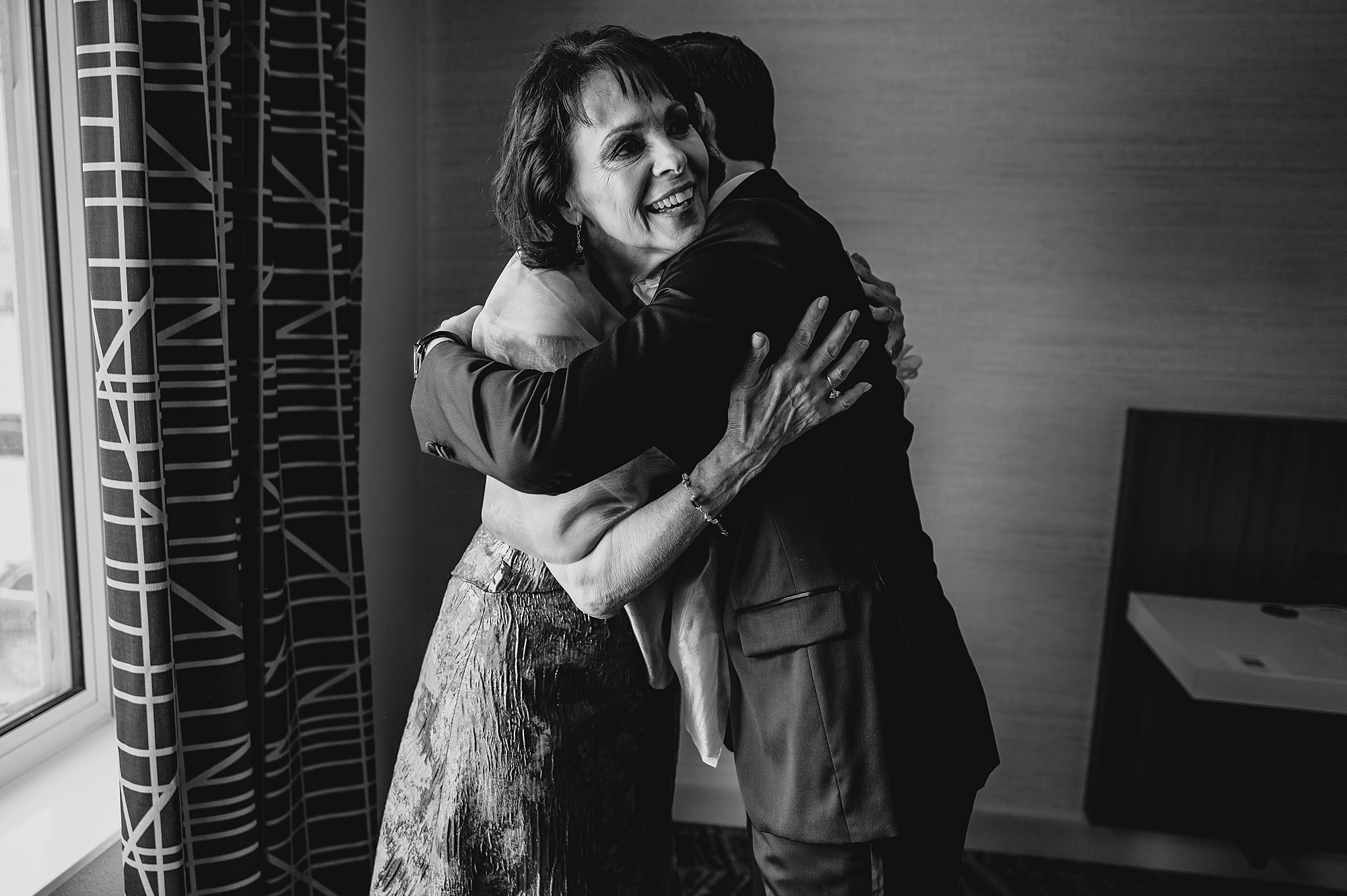 groom hugs mom during prep for NJ wedding day 