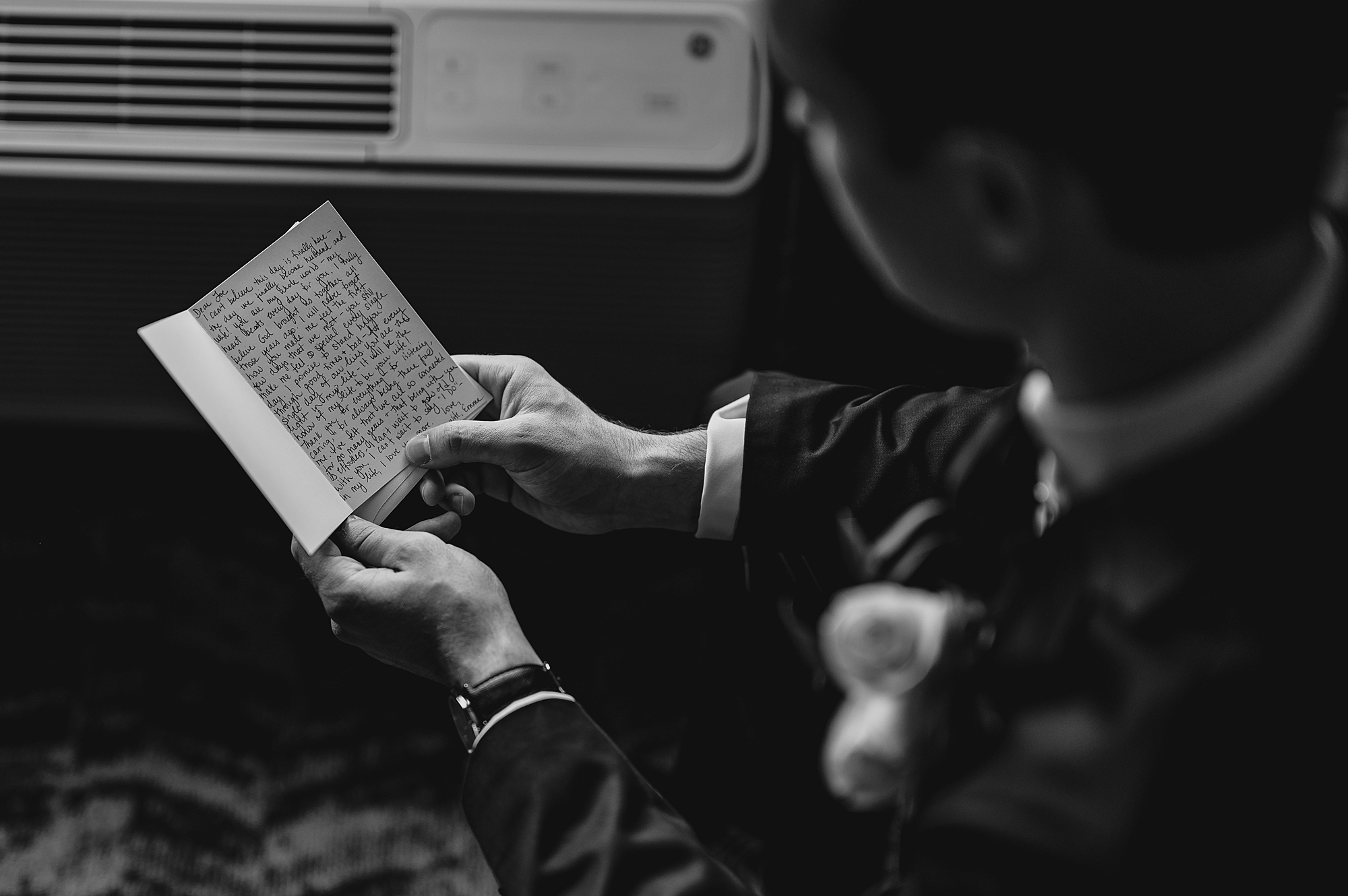 groom reads card on wedding morning 