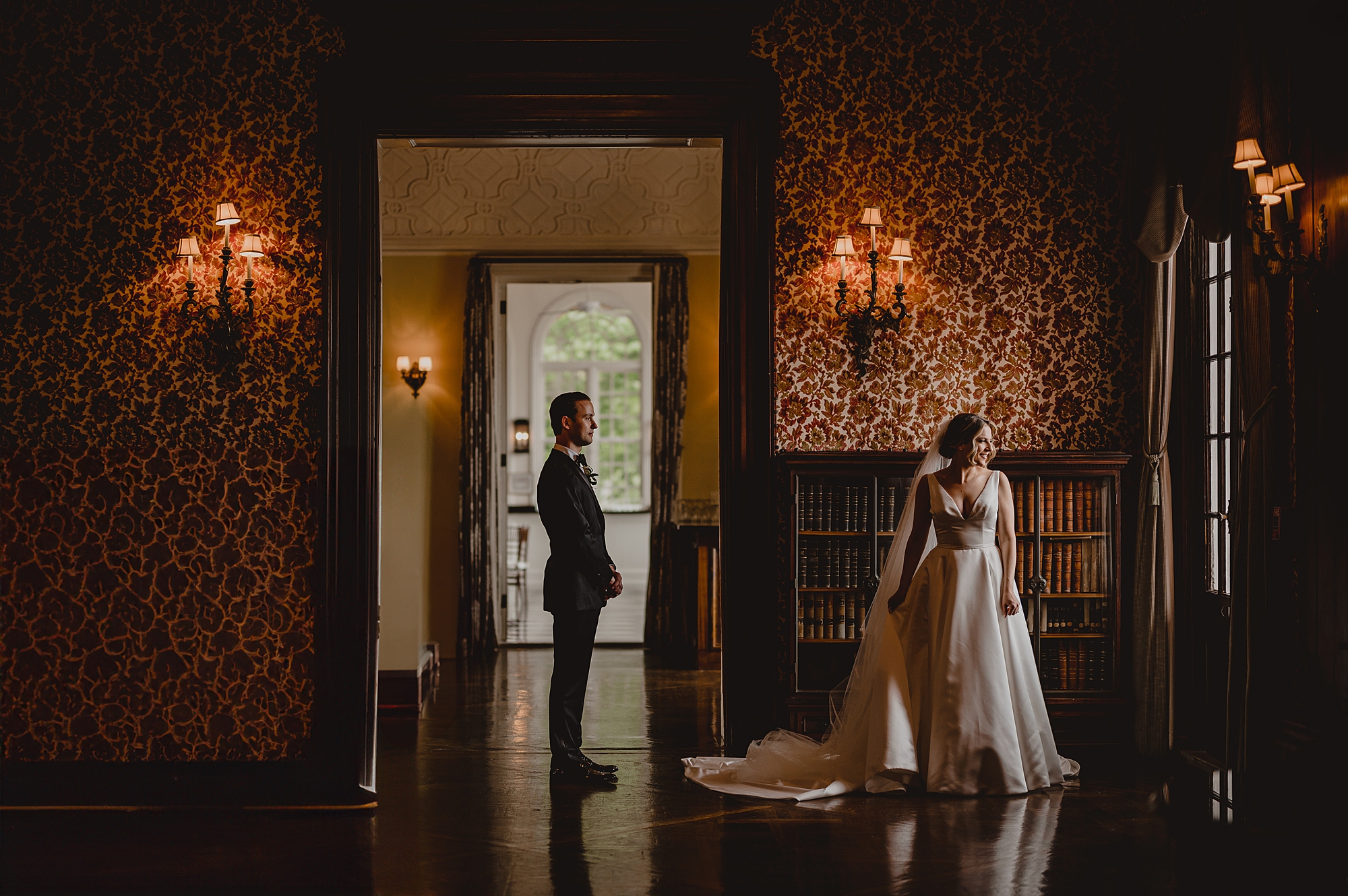 groom stands behind bride inside Bourne Mansion