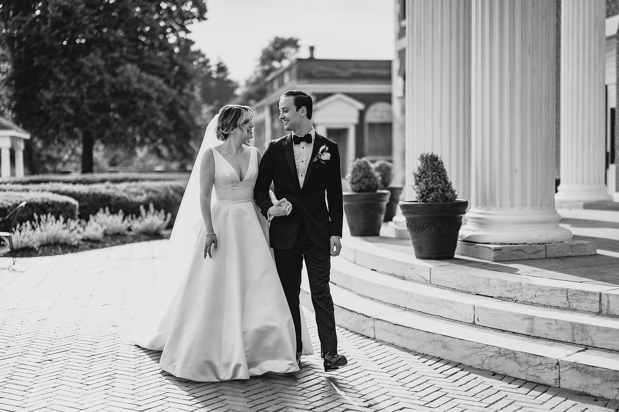 bride and groom walk outside the rotunda at Bourne Mansion
