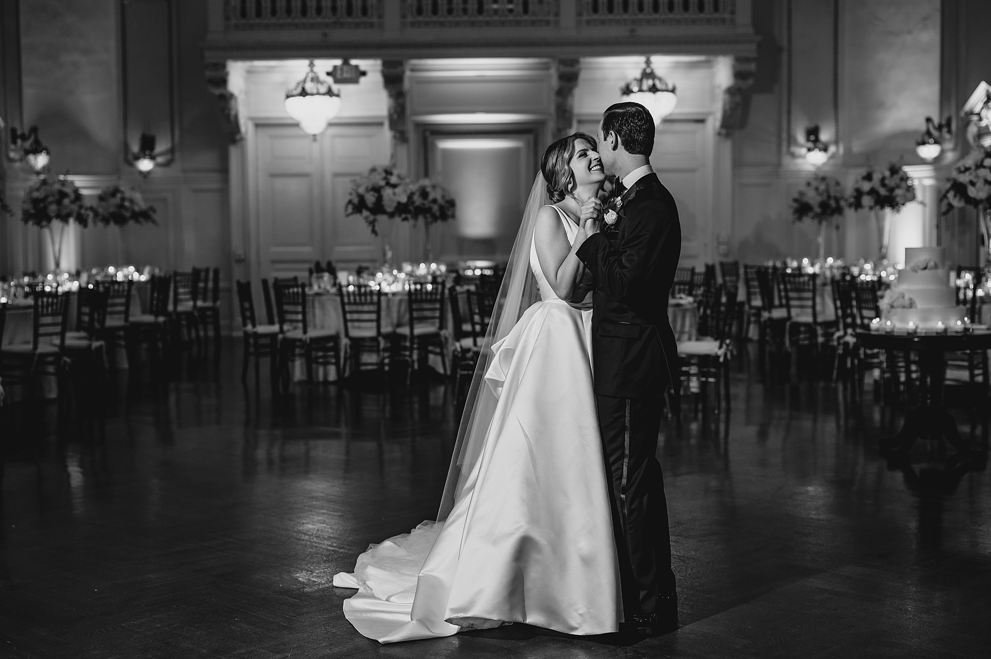 bride and groom hug in reception at Bourne Mansion
