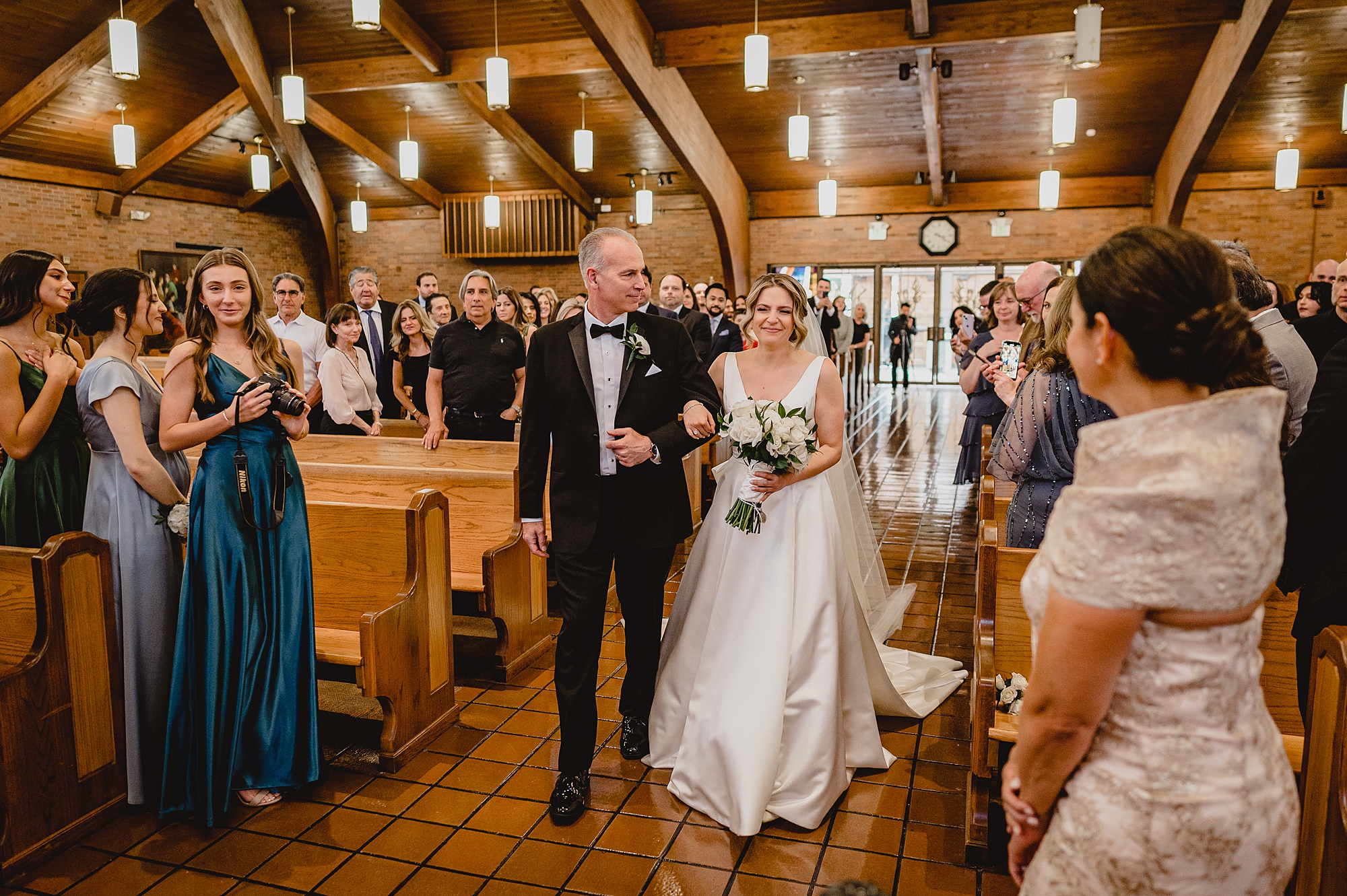 bride and dad walk down aisle for traditional church wedding on Long Island NY