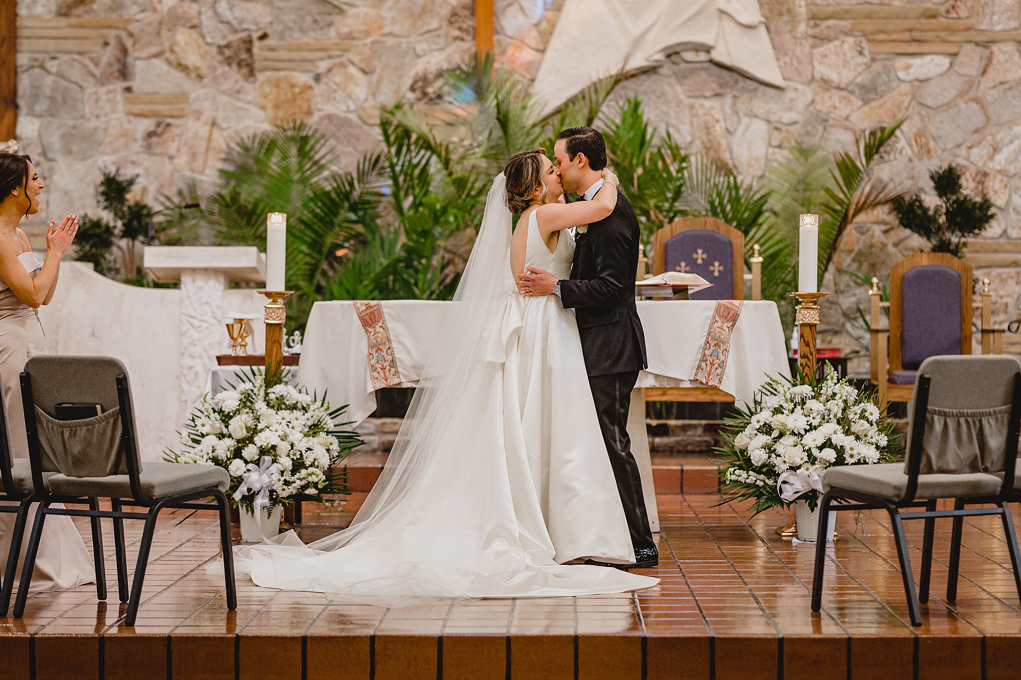 newlyweds kiss on altar during traditional church wedding on Long Island NY