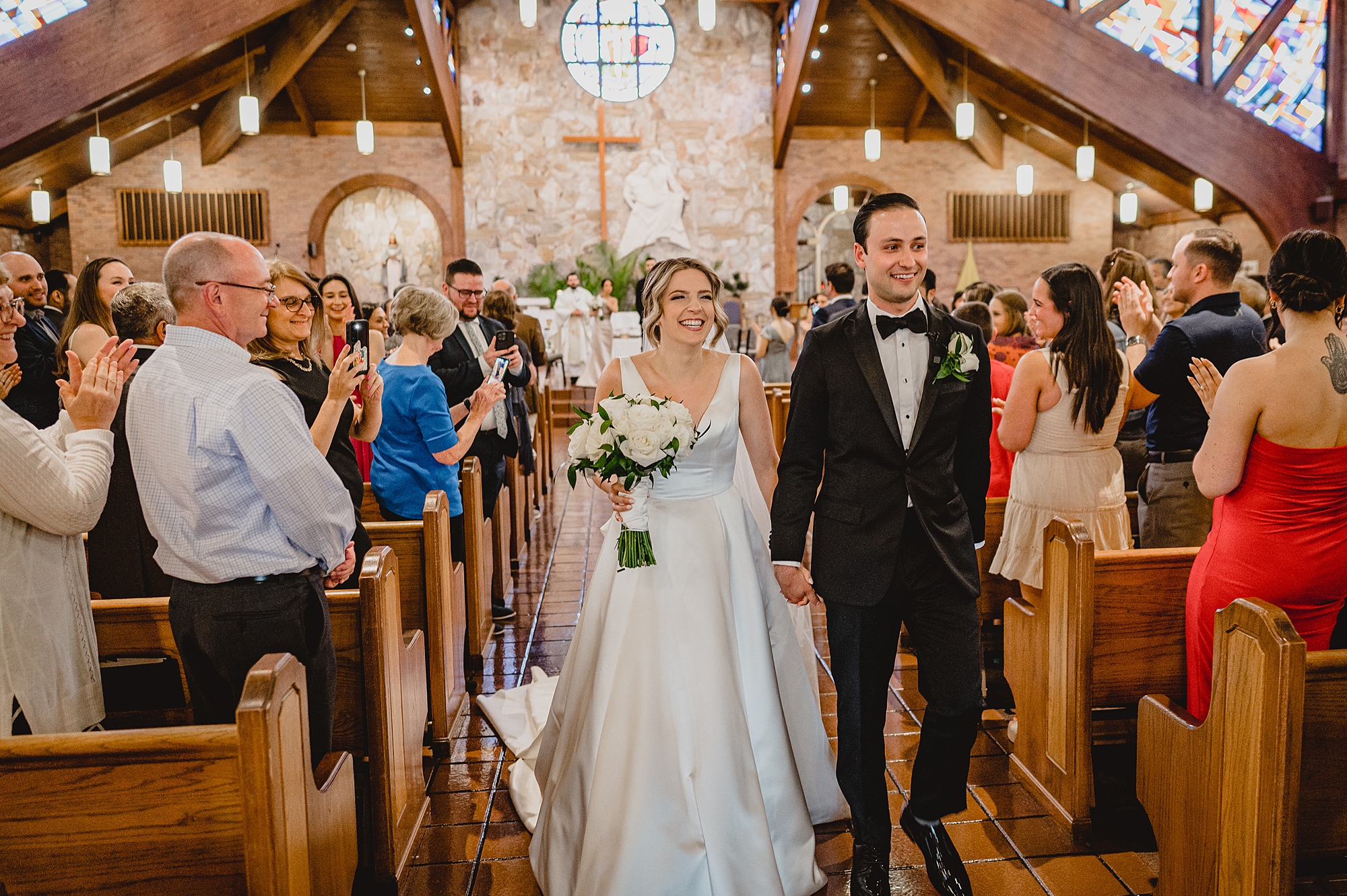 bride and groom walk down aisle during traditional church wedding on Long Island NY