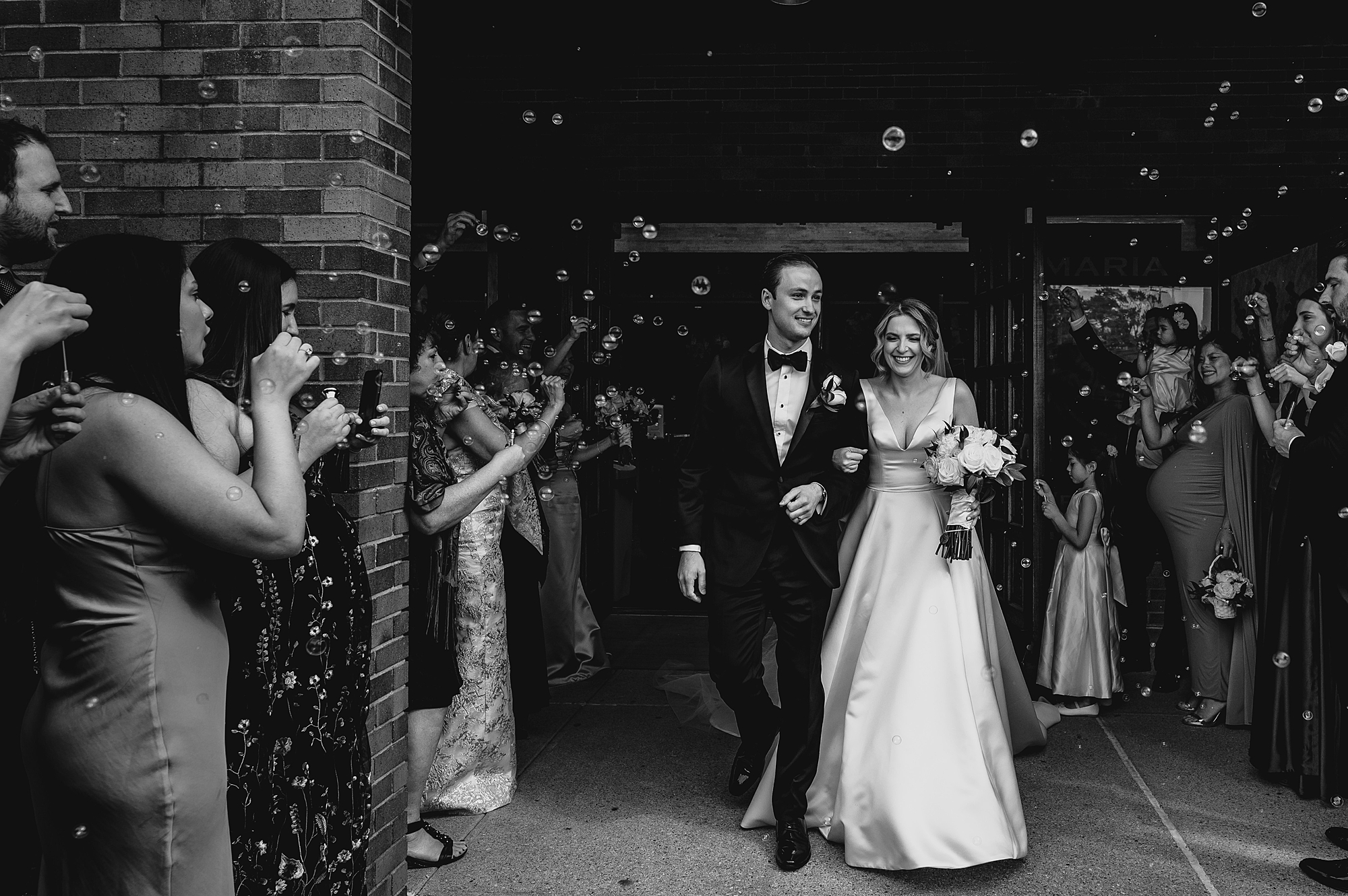 bride and groom leave church ceremony with bubbles 