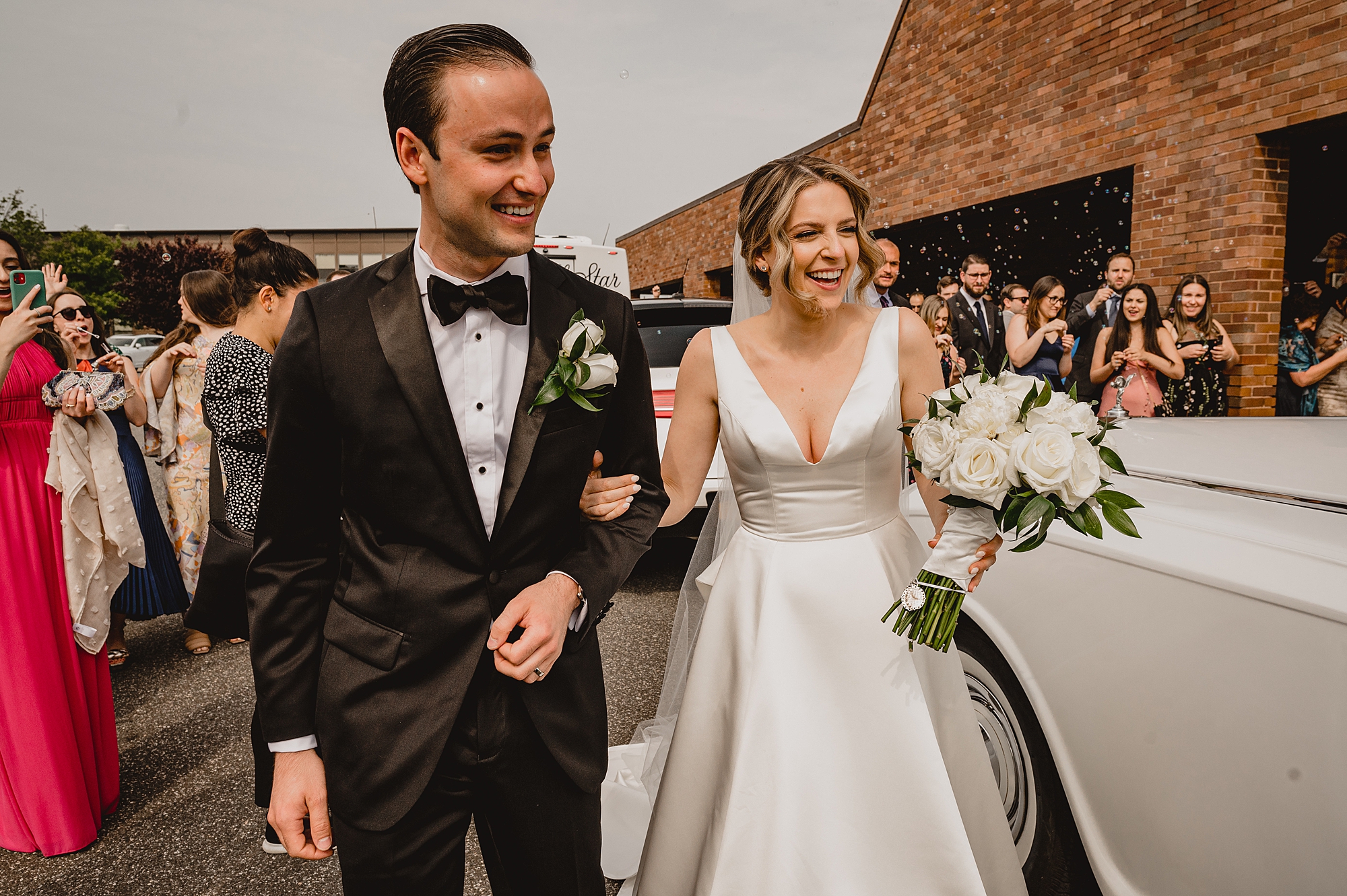 newlyweds laugh leaving Long Island church