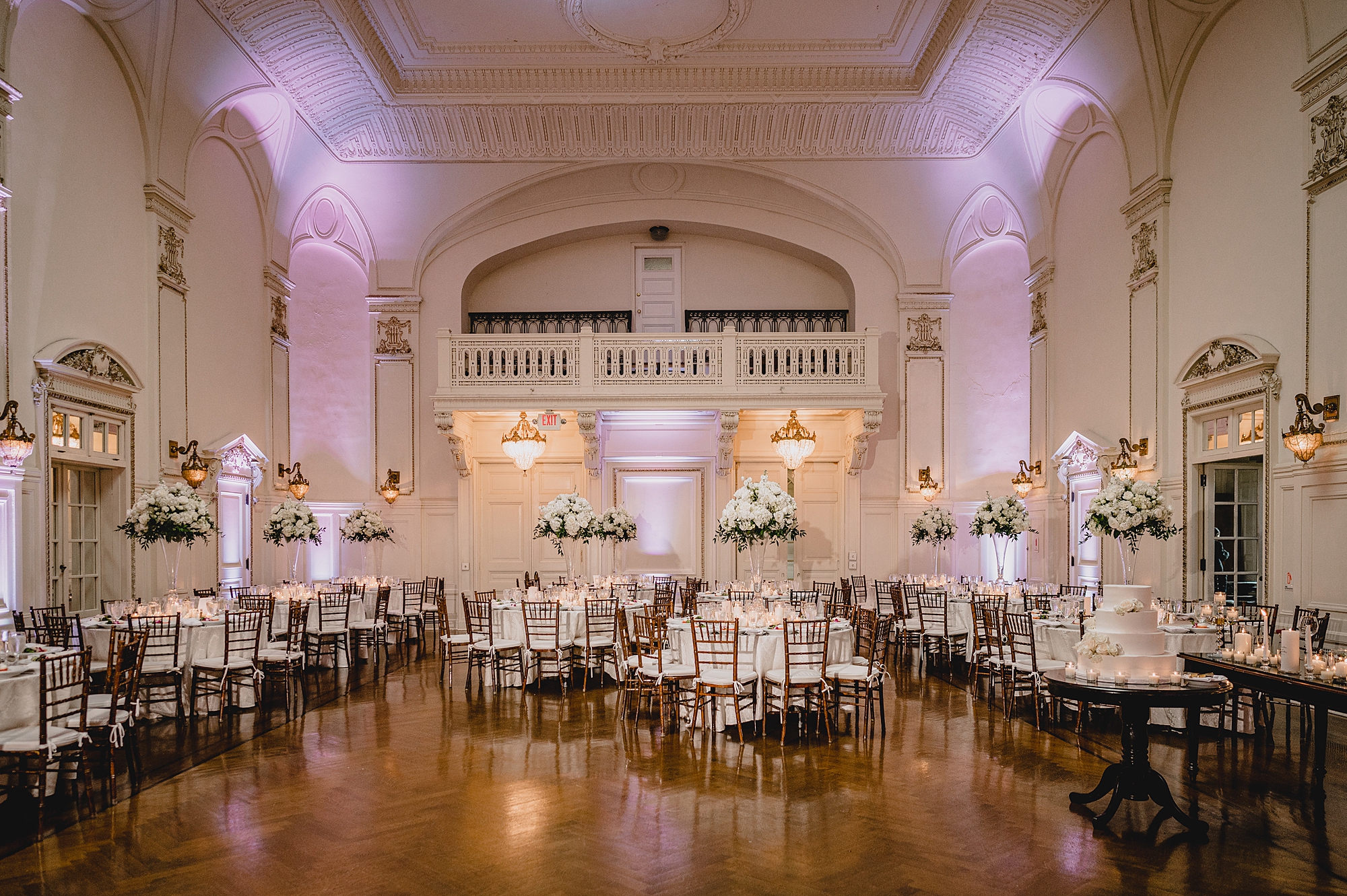 wedding reception with white flowers and purple uplighting at Bourne Mansion