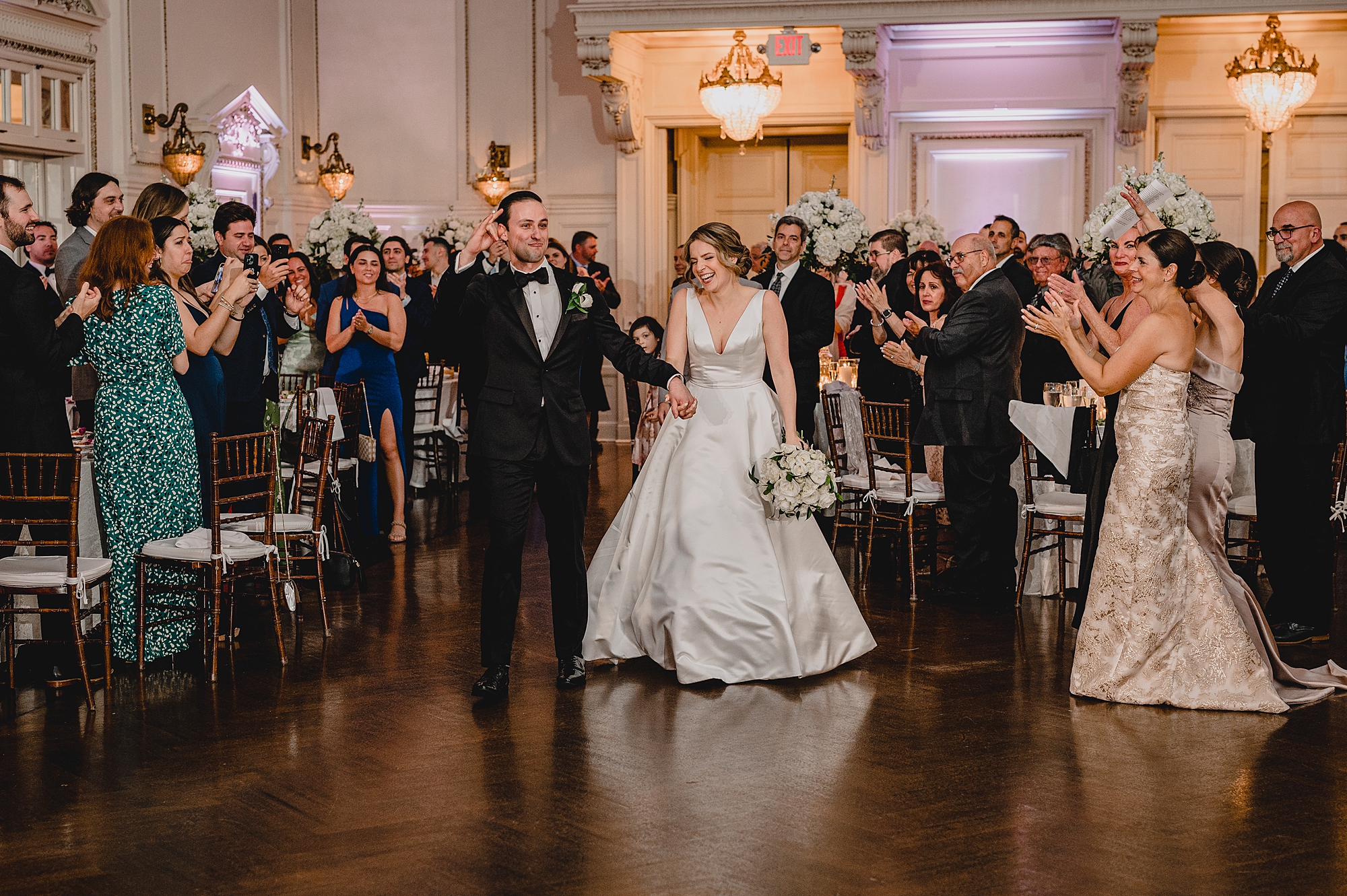 bride and groom enter wedding reception ion at the Bourne Mansion