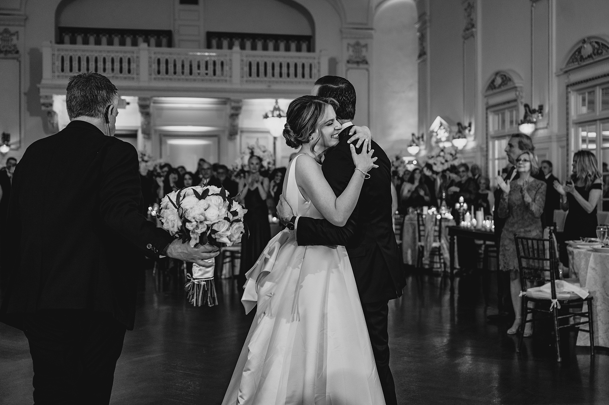bride hugs groom on dance floor at Bourne Mansion