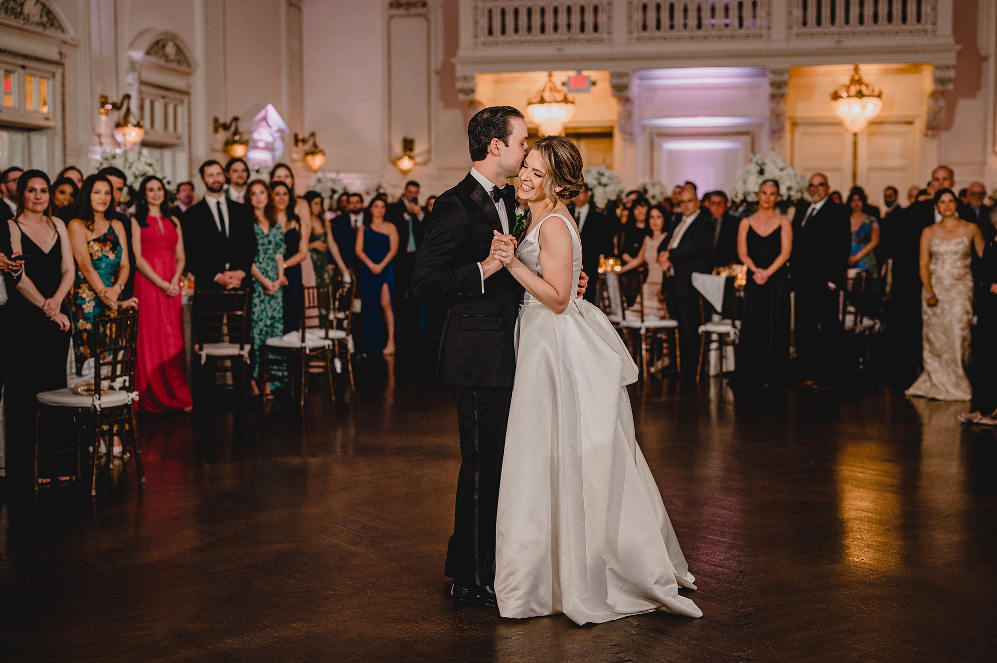 bride and groom dance during Long Island wedding reception in the ballroom