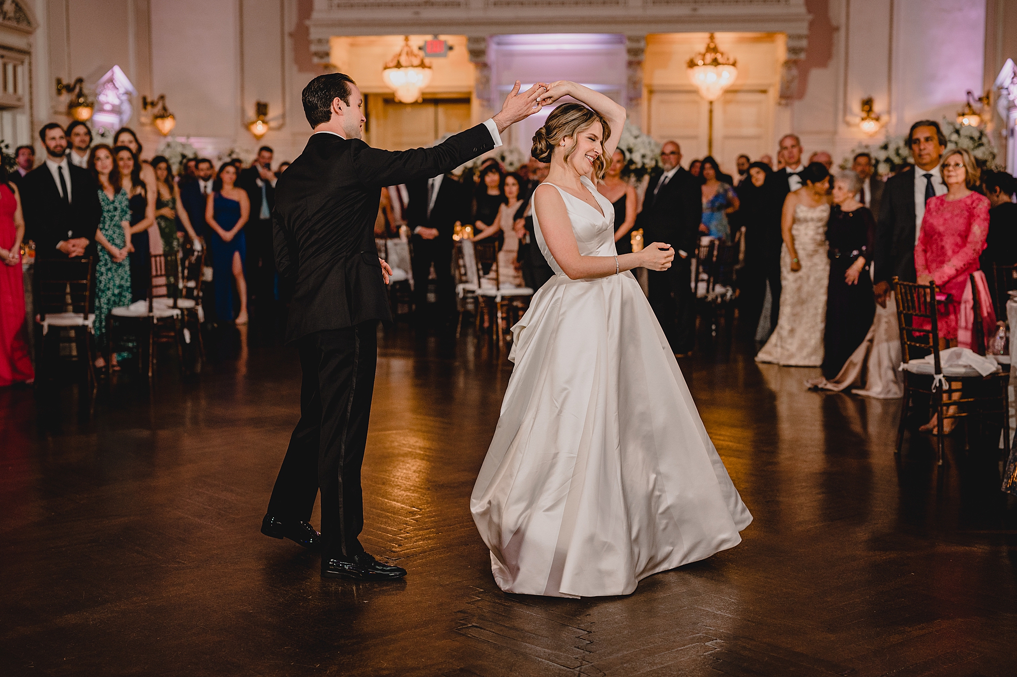 bride and groom dance during Long Island wedding reception in the ballroom