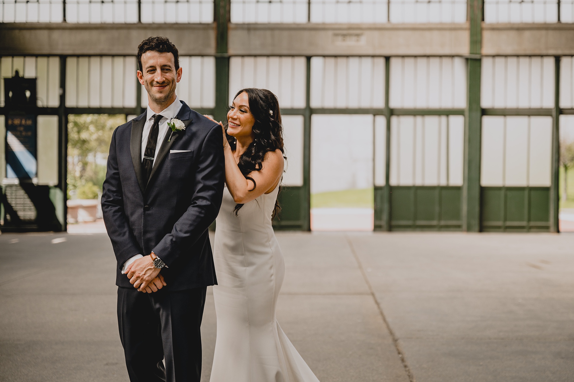 bride taps groom's shoulder during first look at the Liberty House