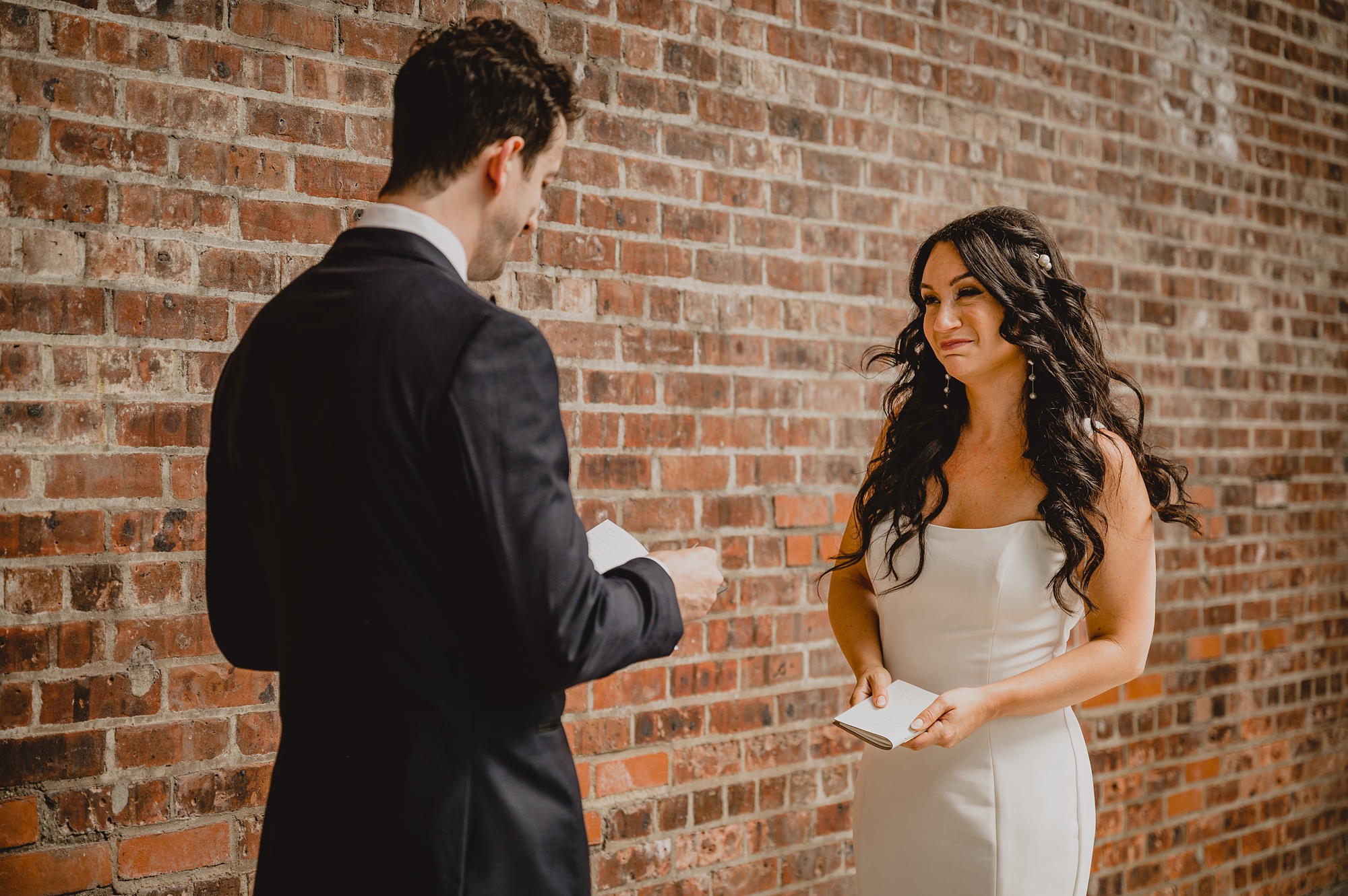 bride and groom read vows during first look at the Liberty House