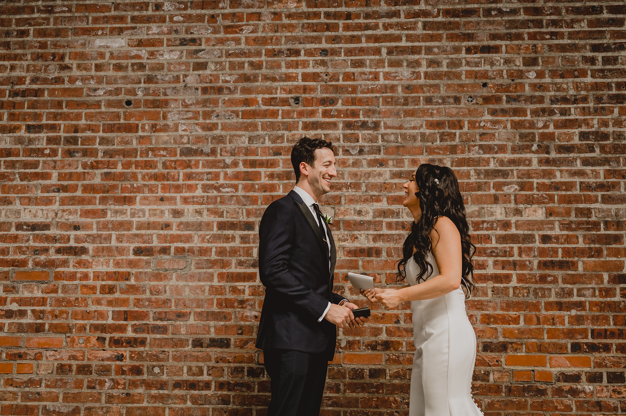 bride and groom laugh during first look at the Liberty House